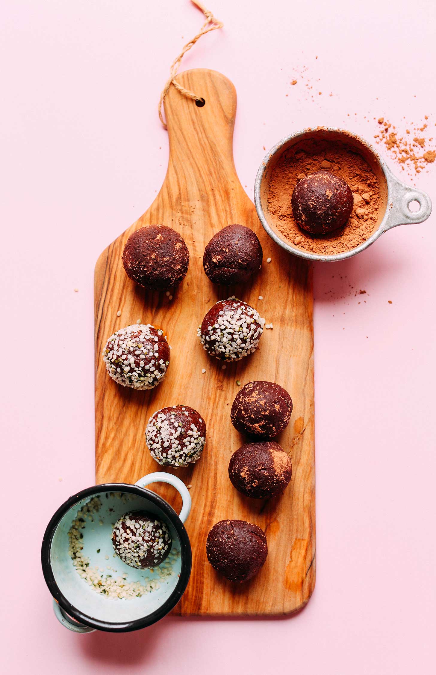 Wood board with Fudgy Dark Chocolate Hemp Energy Bites for a protein-rich vegan snack