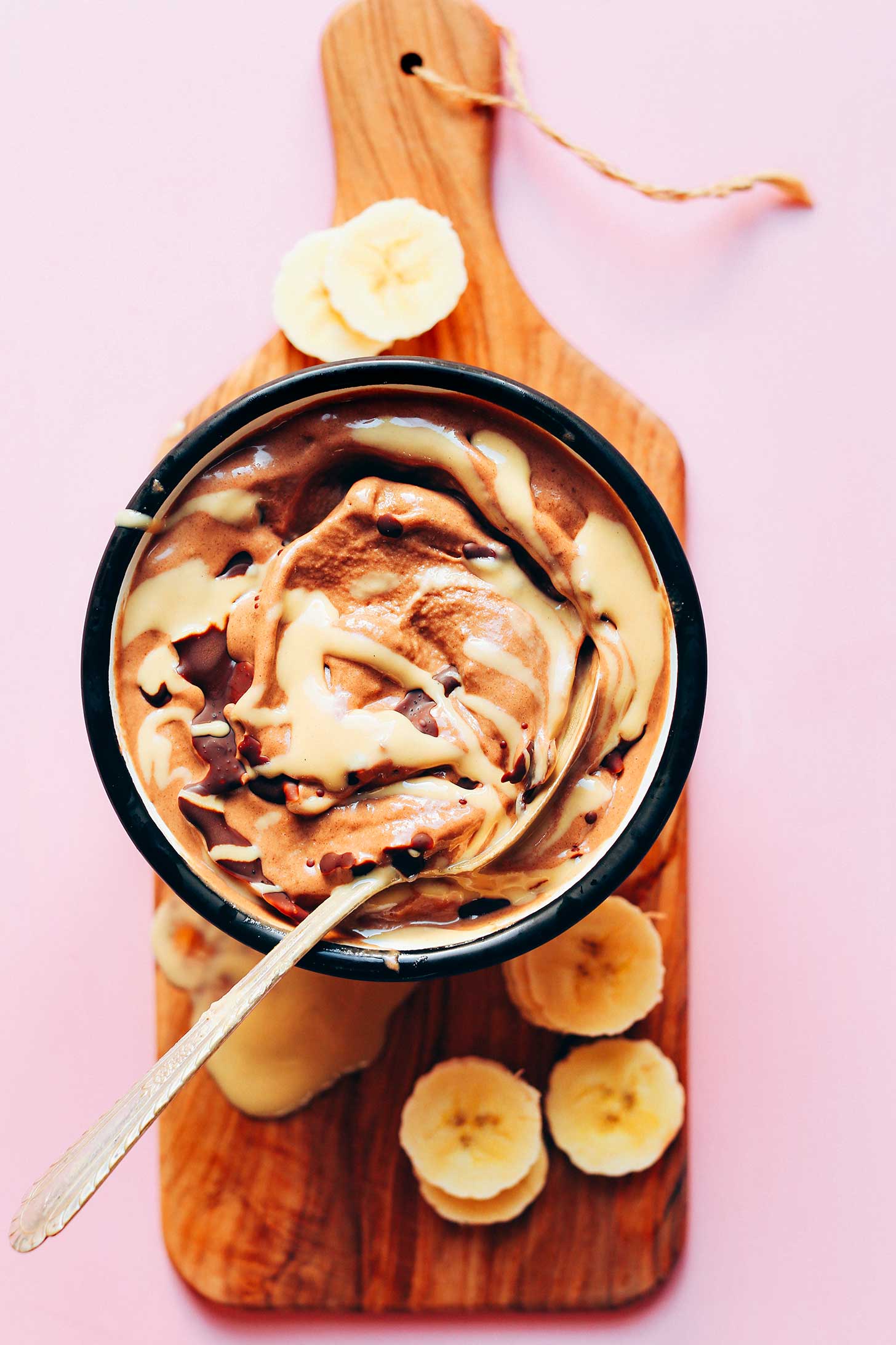 Close up shot of a bowl filled with delicious Chocolate Tahini Banana Soft Serve that's gluten-free and vegan