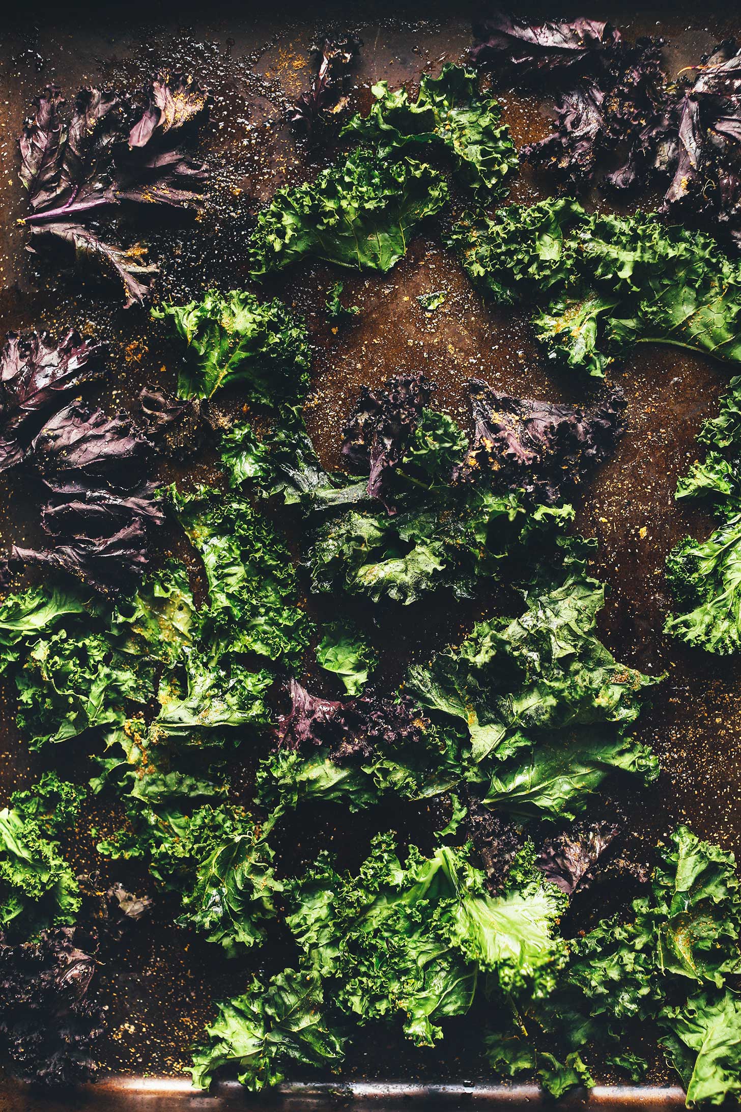 Crispy kale chips on a baking sheet ready to be turned into vegan Kale Nachos