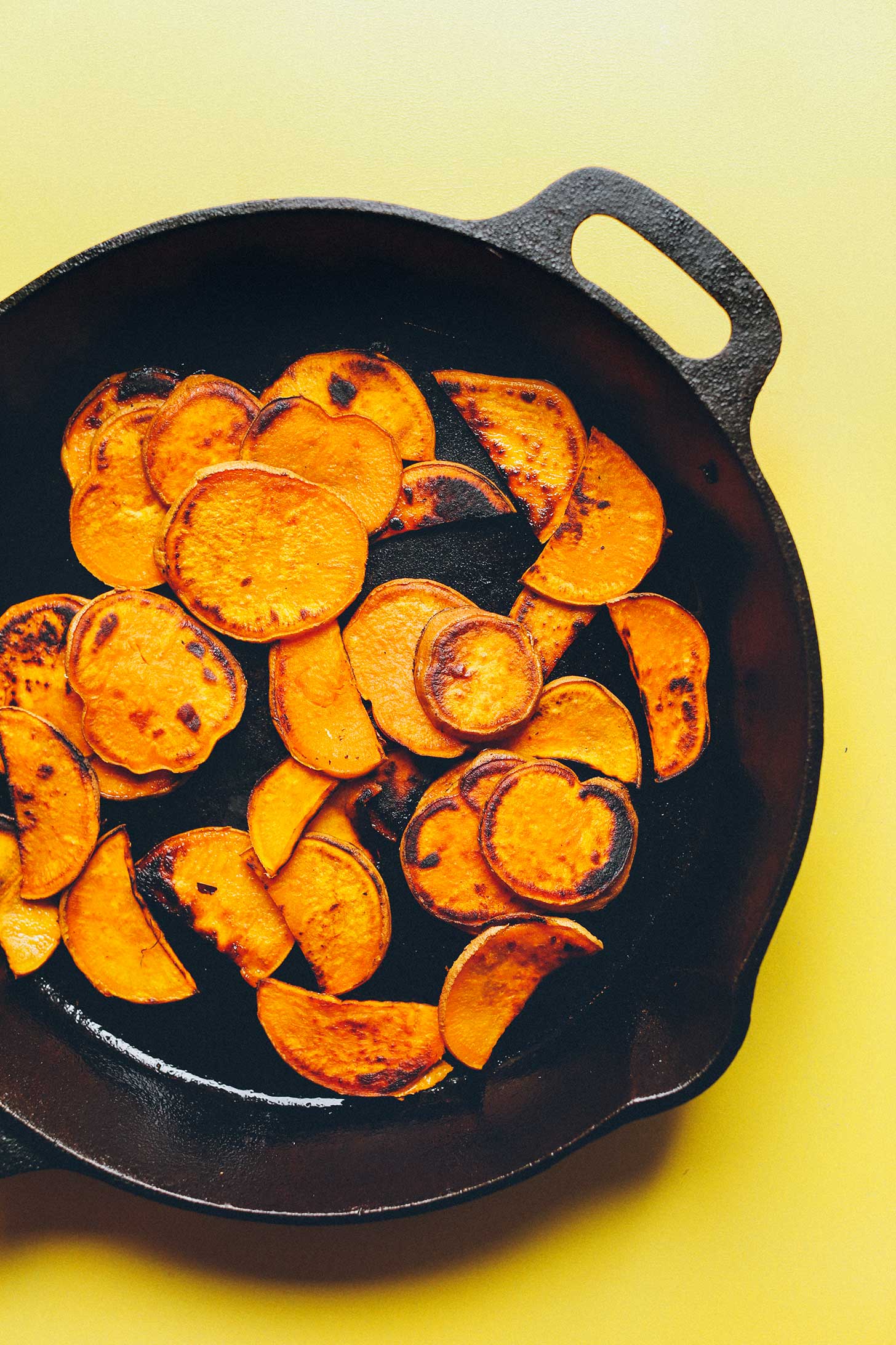 Cooking cast-iron skillet sweet potatoes for healthy plant-based kale nachos