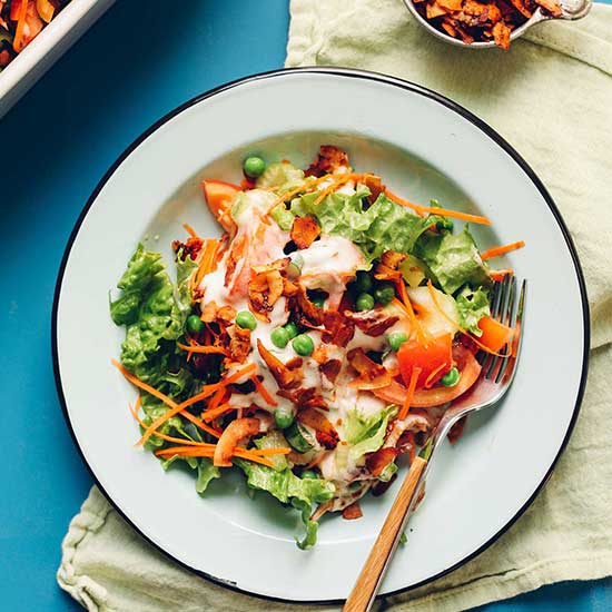 Fork resting on a plate of Vegan 7-Layer Salad