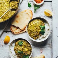 Bowls and pan of Vegan Lentil Dahl and fresh naan
