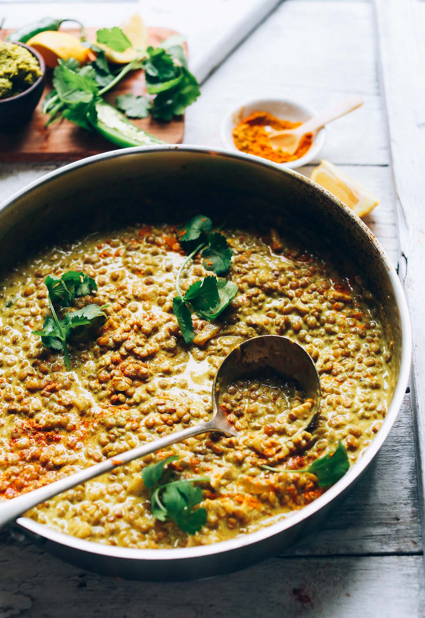 Using a ladle to scoop up some Vegan Lentil Dal for a delicious plant-based dinner