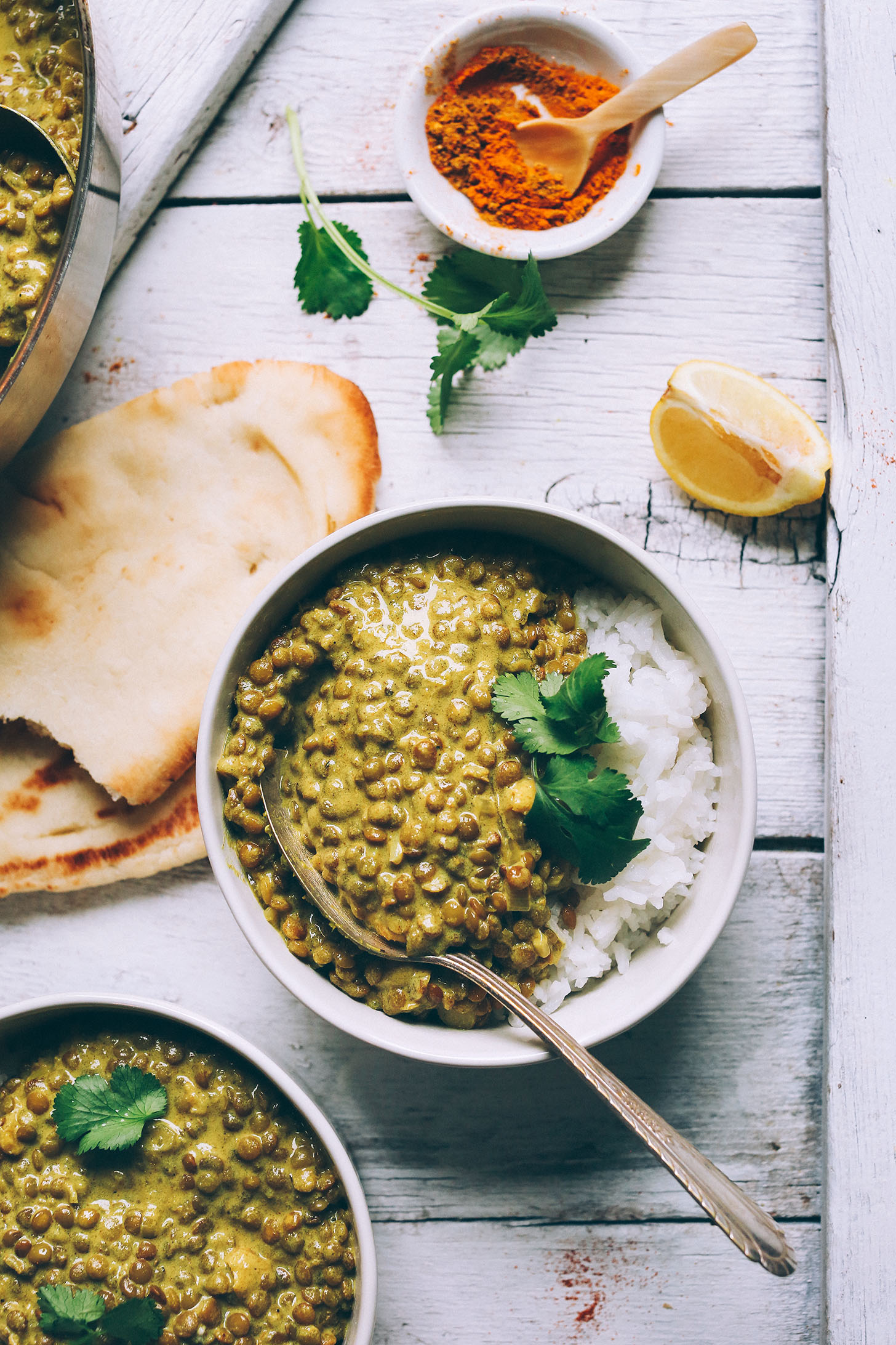 A bowl of rice and Vegan Lentil Dal topped with cilantro