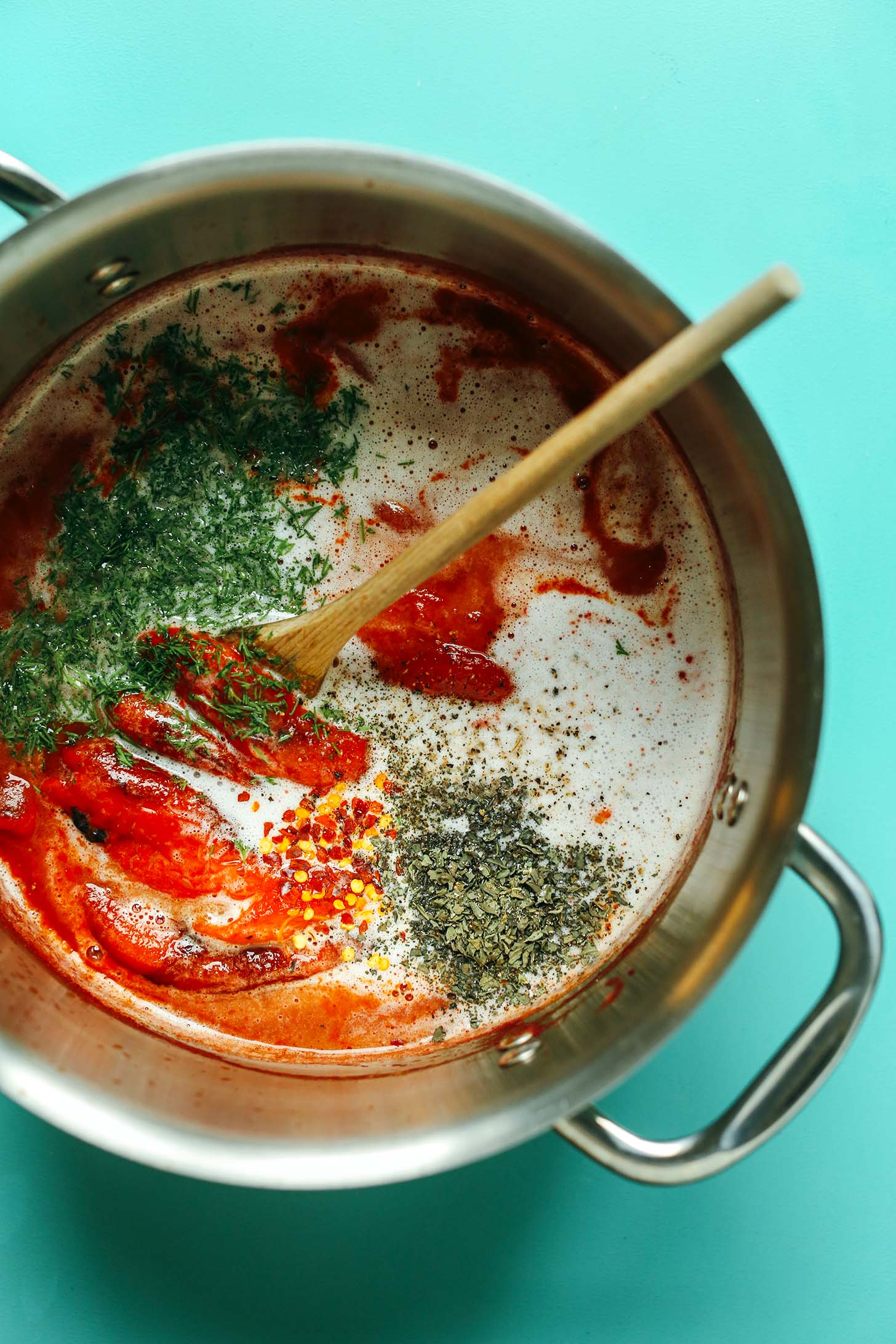 Stirring together a big soup pot of Creamy Vegan Roasted Red Pepper Tomato Soup