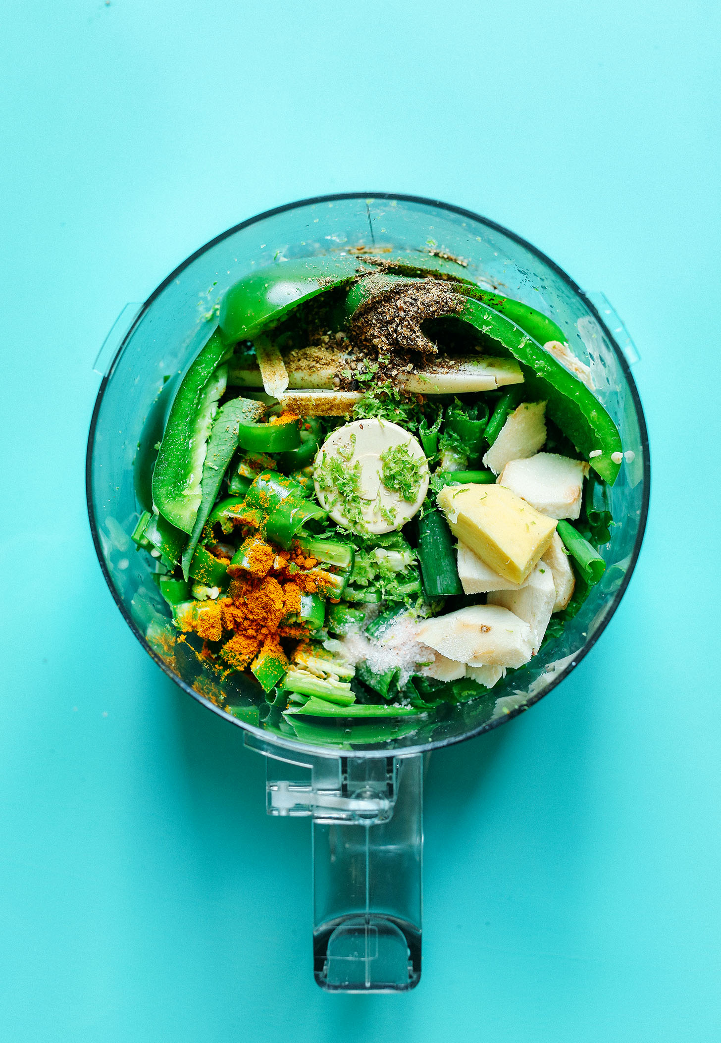 Food processor with ingredients for making homemade gluten-free Green Curry Paste