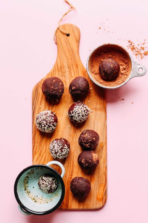 Wood board full of Fudgy Dark Chocolate Hemp Energy Bites