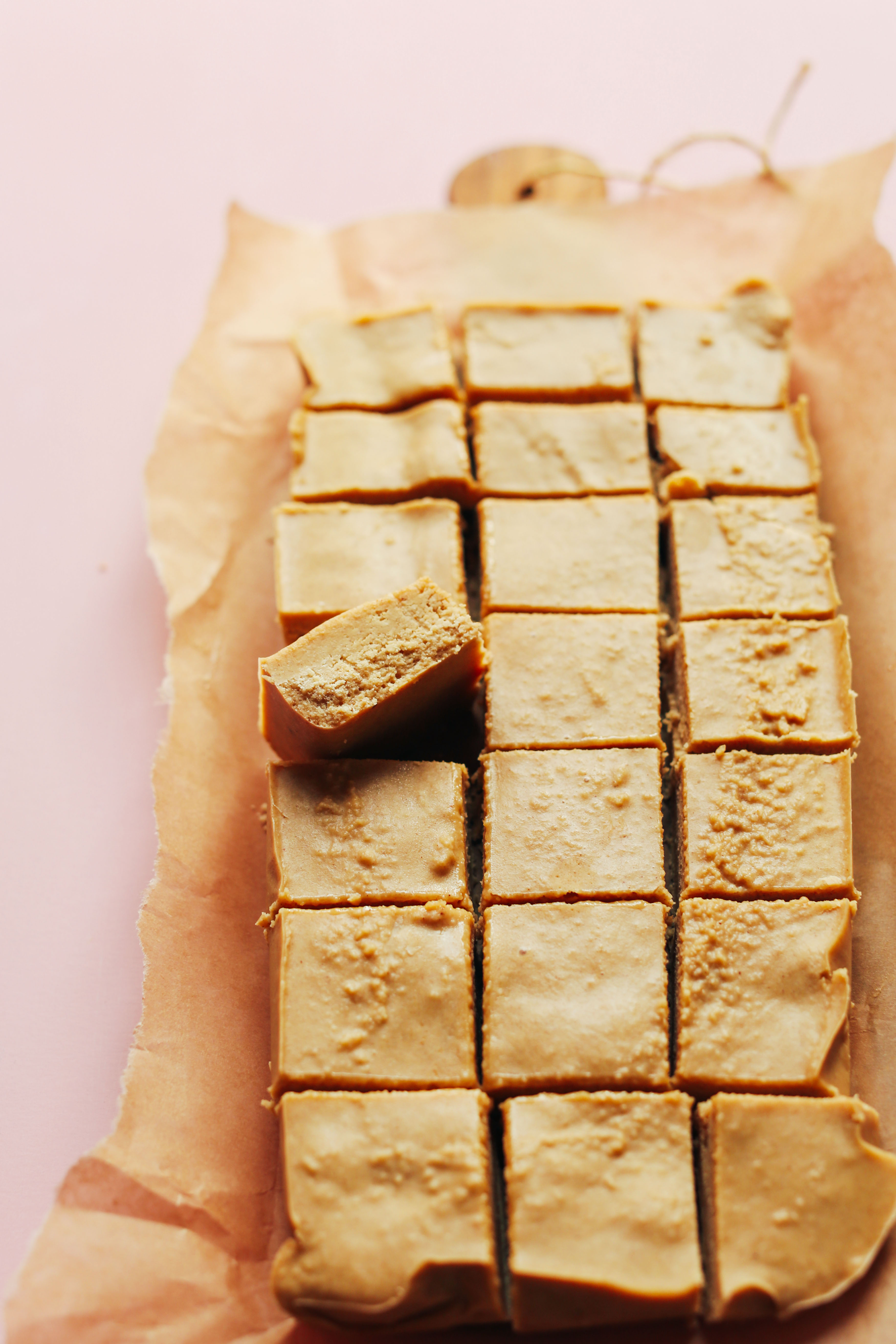 Parchment paper with freshly cut gluten-free vegan Peanut Butter Fudge
