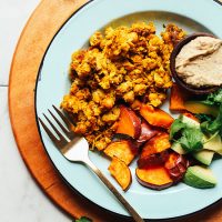 Plate of roasted sweet potato, avocado, baba ganoush, and Vegan Chickpea Scramble