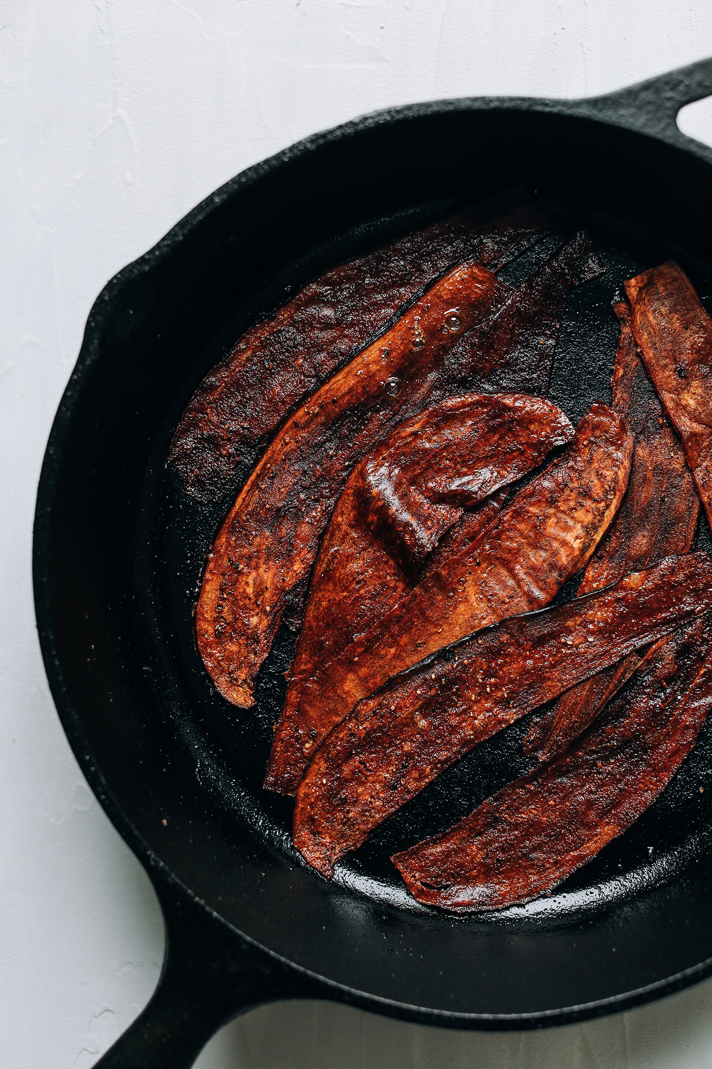 Making eggplant bacon in a cast-iron skillet