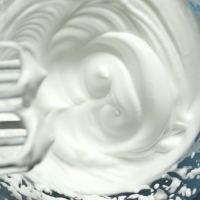 Showing freshly whipped peaks of aquafaba in a bowl