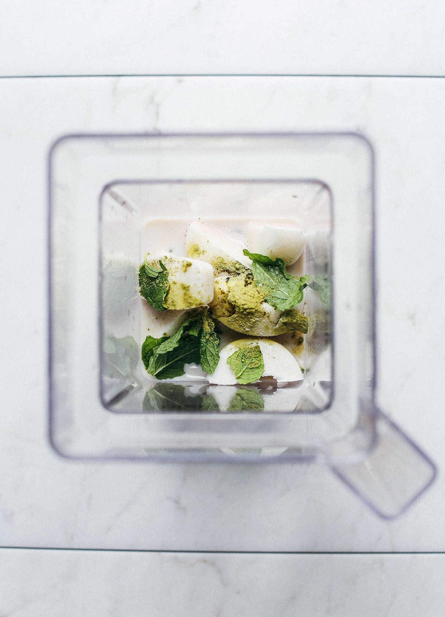 Blender with ingredients for making our Vegan Mint Matcha Shamrock Shake recipe