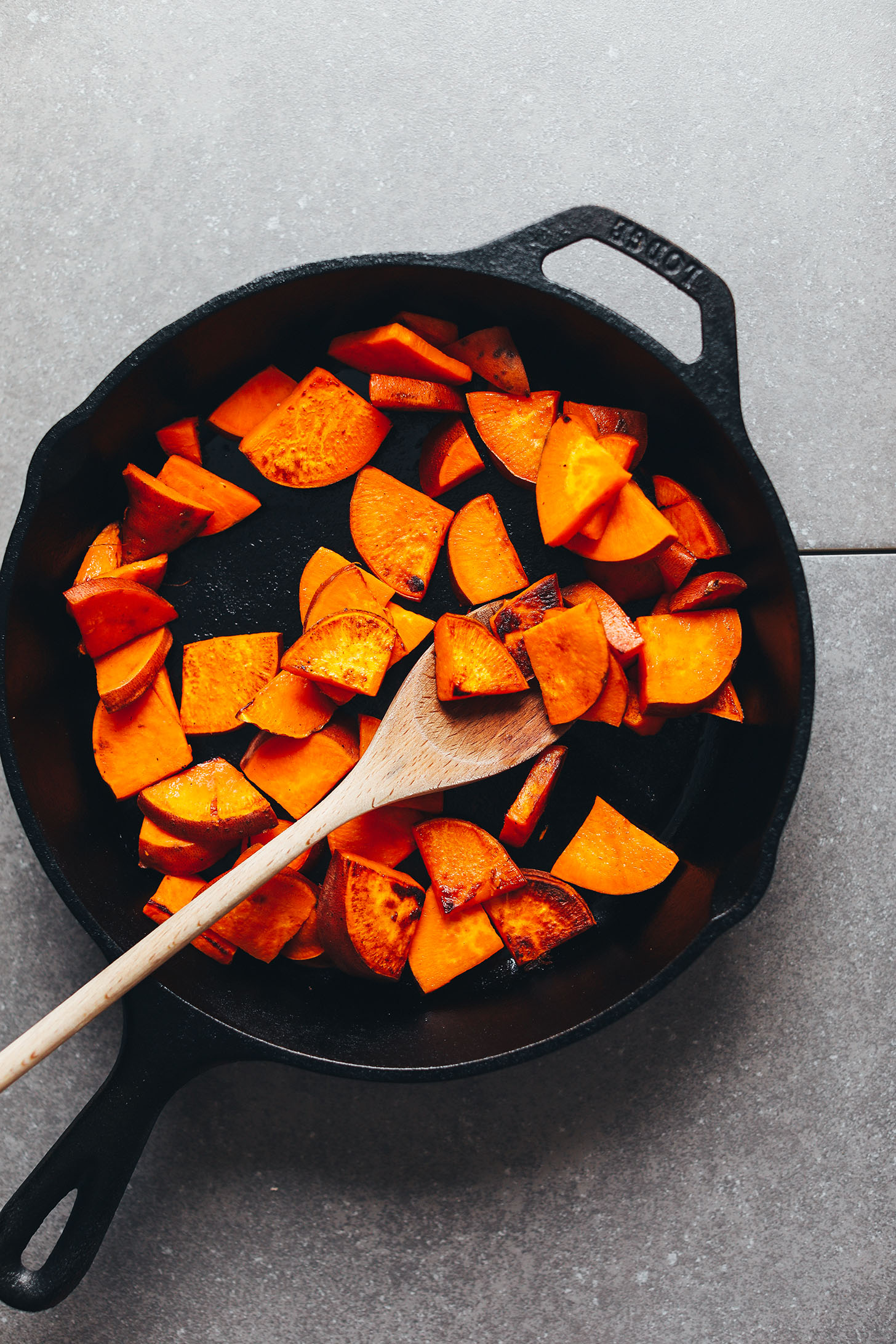 Browning sweet potatoes in a cast iron skillet for Vegan Breakfast Salad
