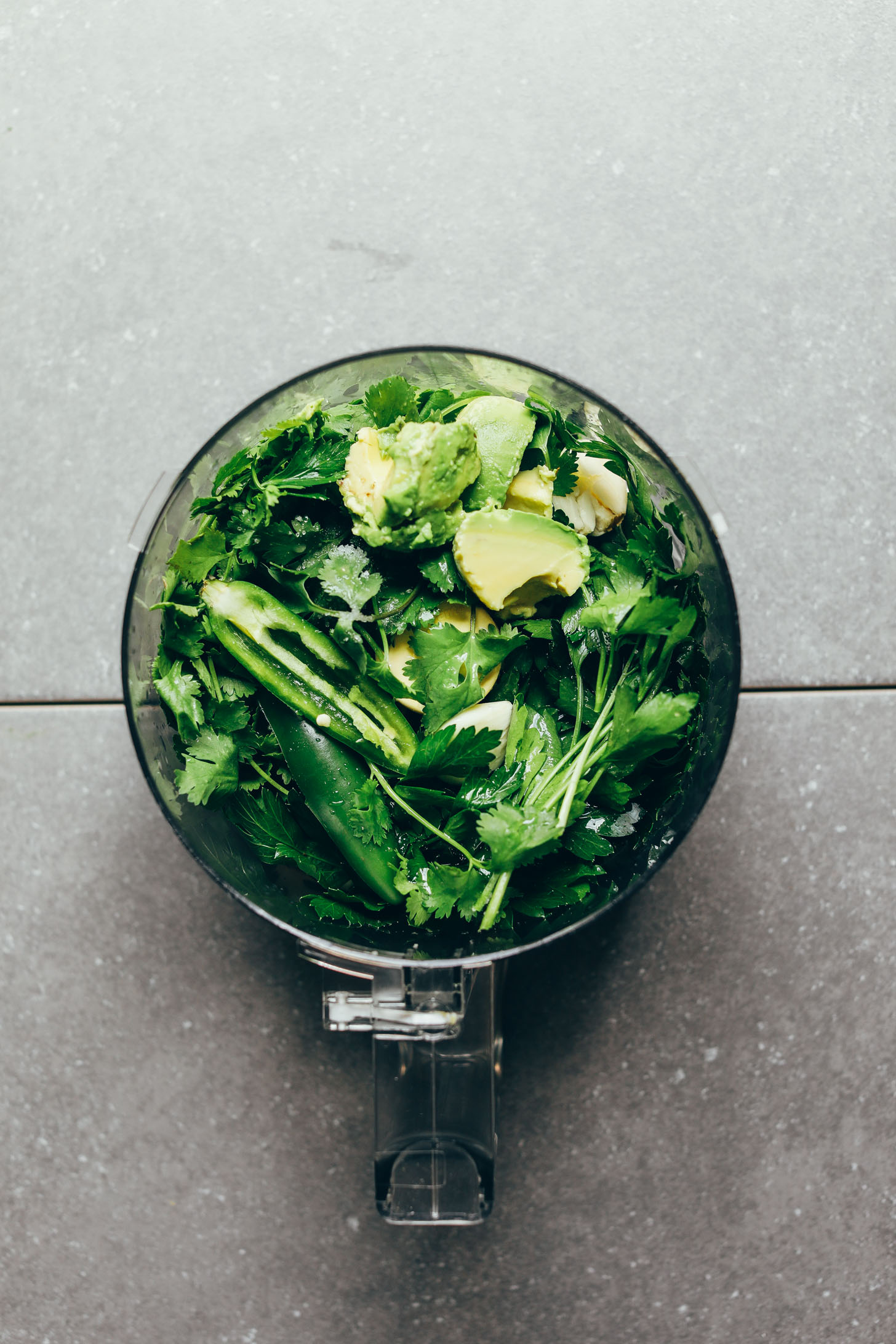 Ingredients in a food processor ready to be made into delicious Green Chimichurri