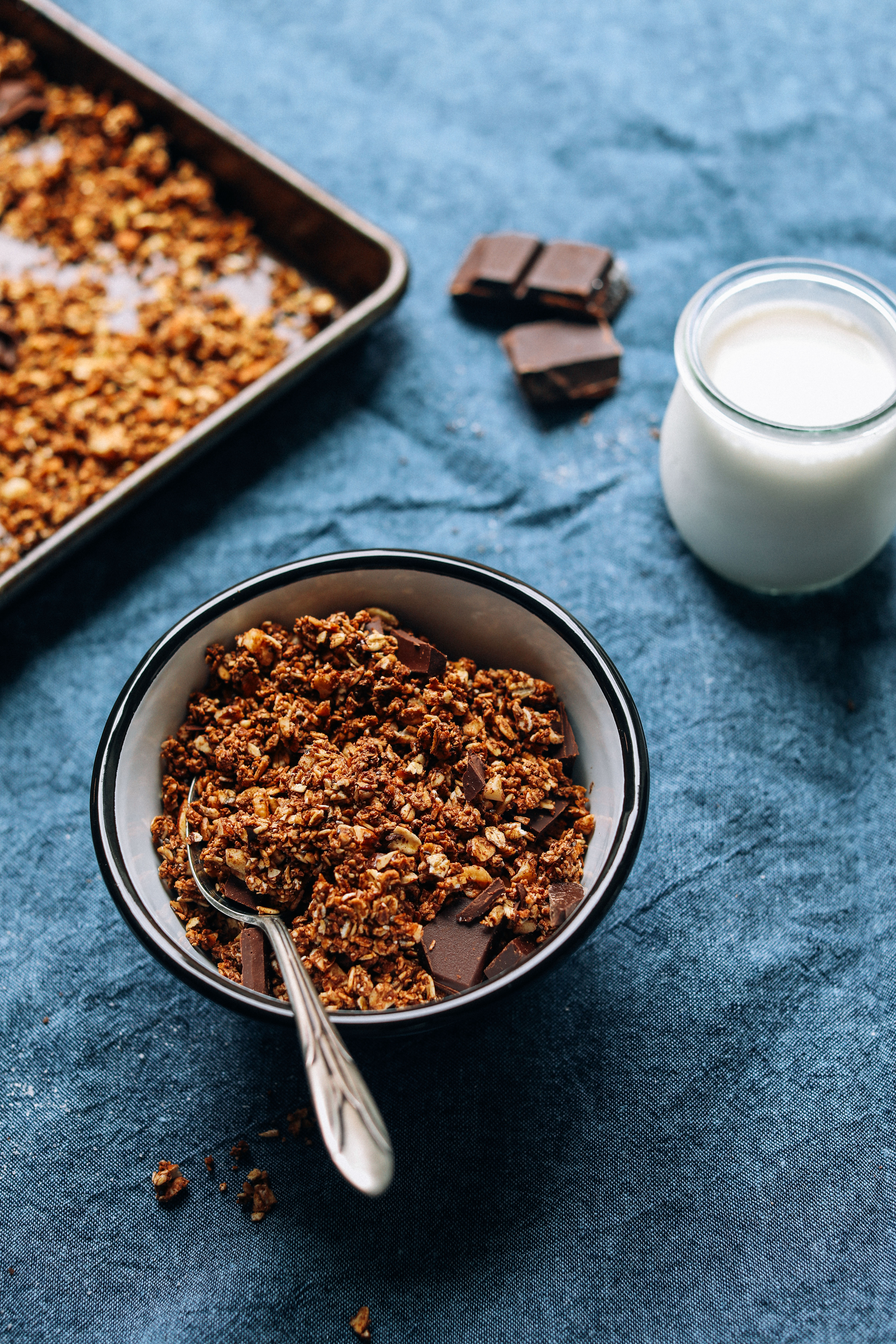 Bowl of gluten-free Dark Chocolate Granola with a side of dairy-free milk