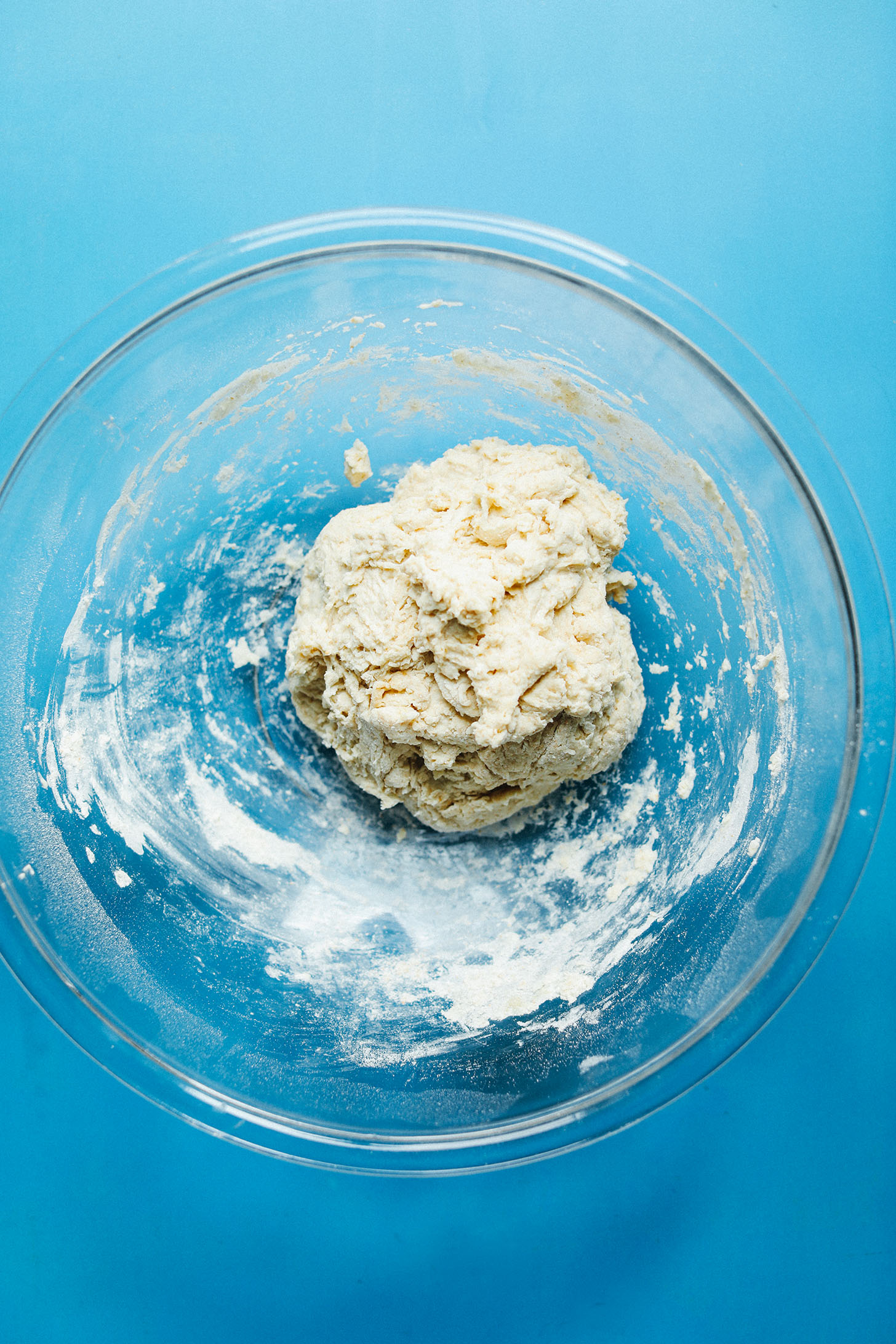 Glass mixing bowl with dough for making our fluffy Vegan Naan recipe