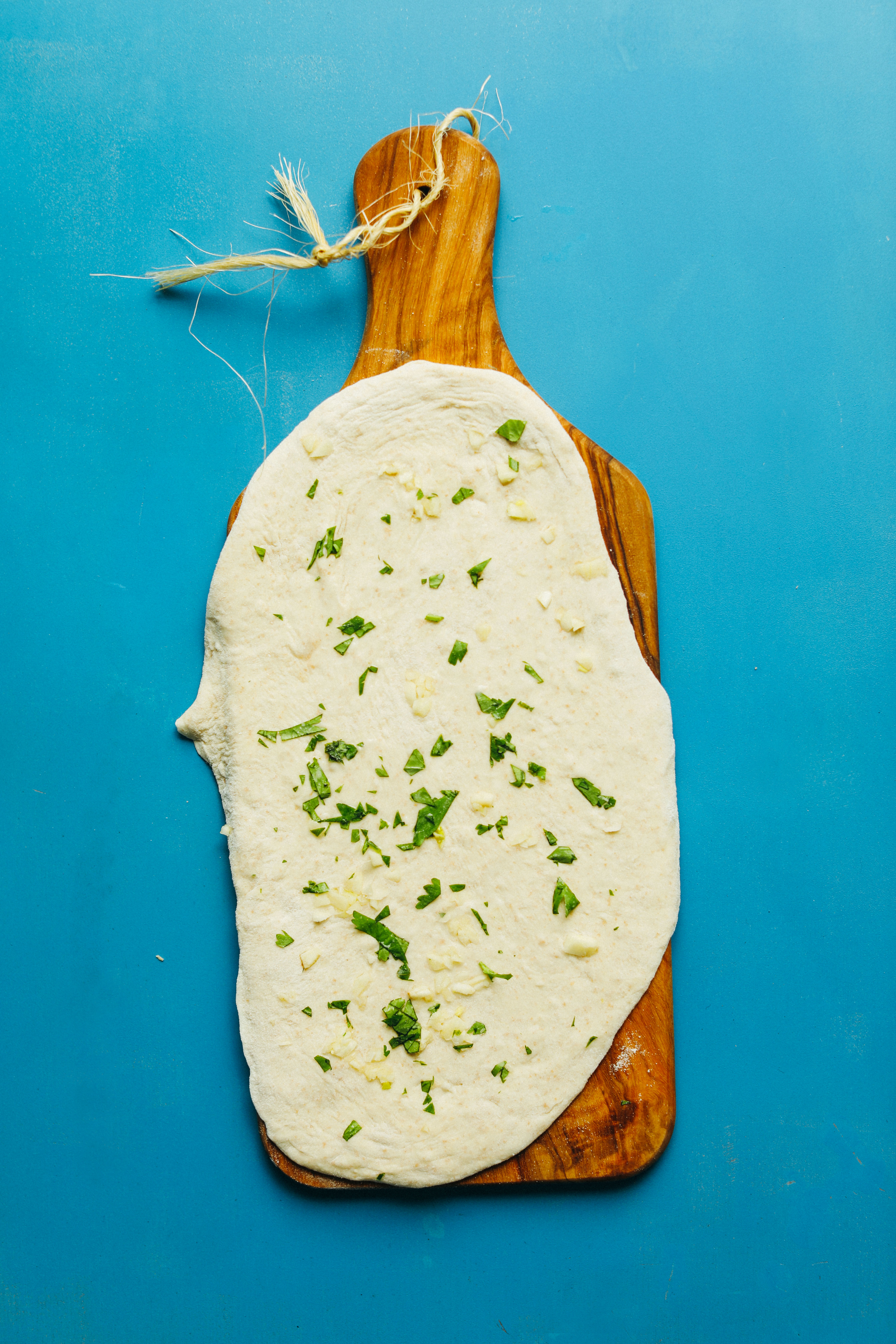 Wood cutting board with rolled out dough for Perfect Vegan Naan