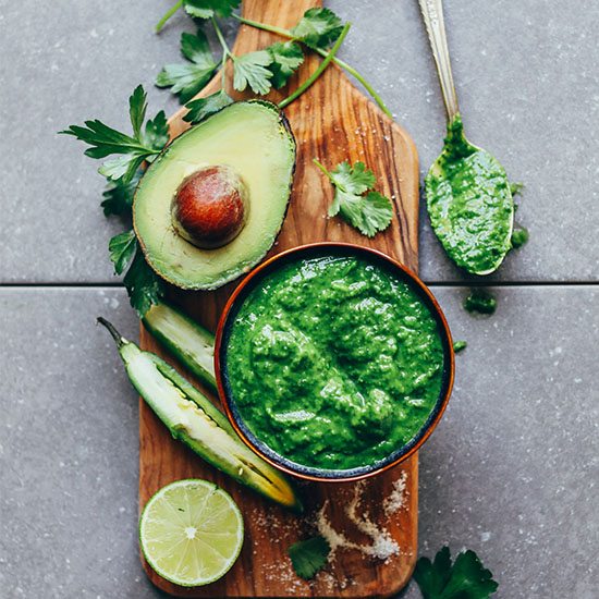Wood board filled with ingredients for making our Vegan Chimichurri recipe