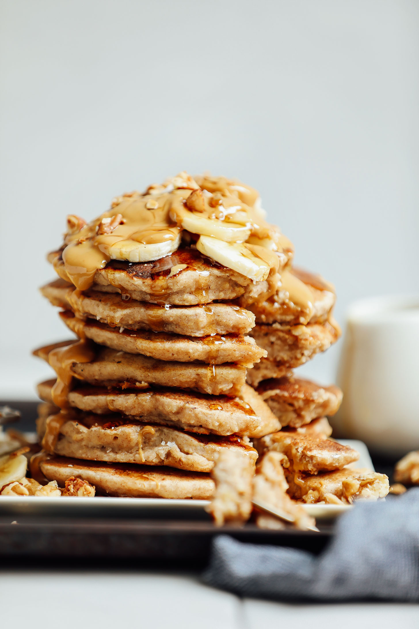 Stack of gluten-free vegan Banana Pancakes with a bite taken out