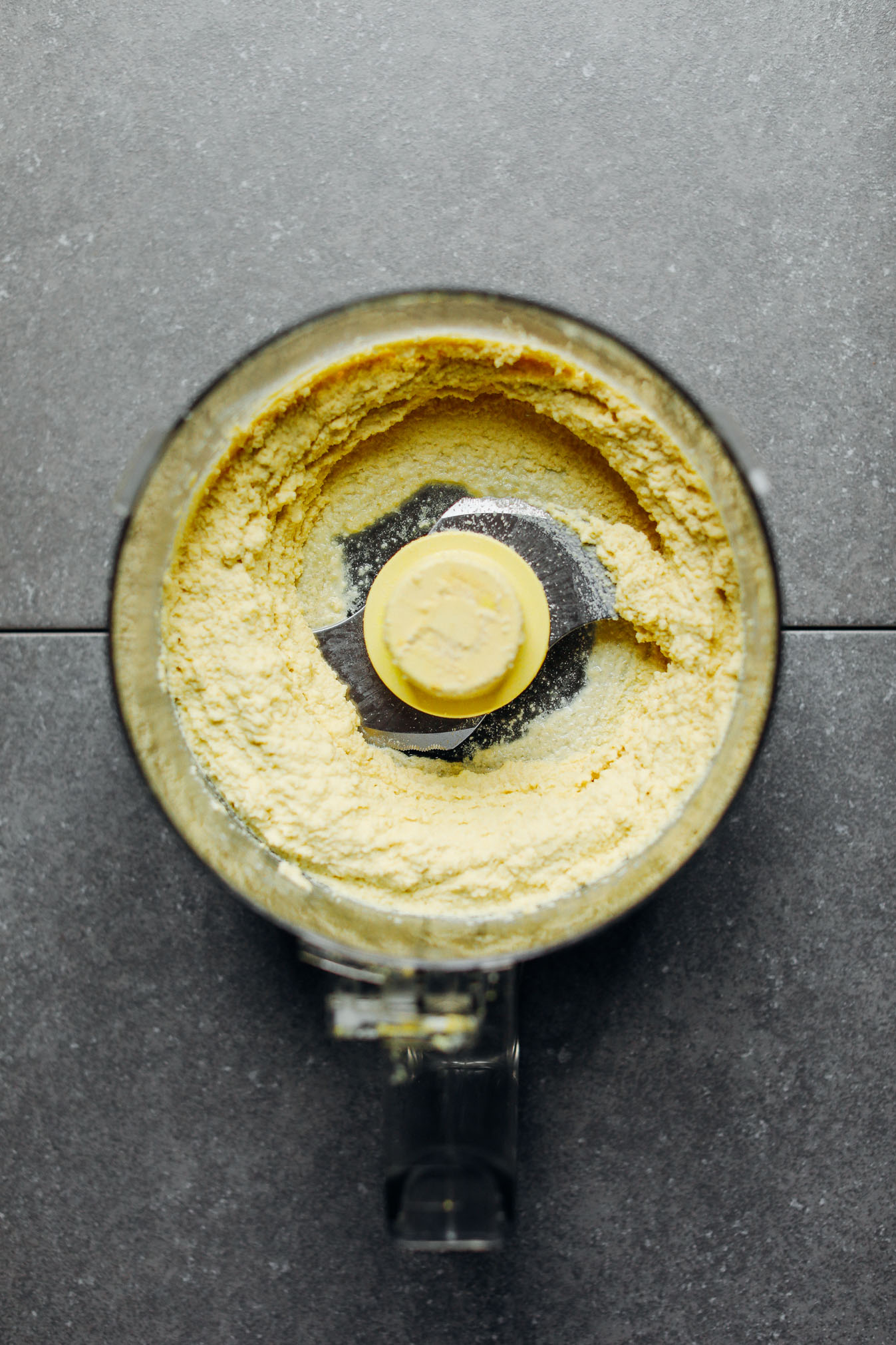 Food processor with freshly blended vegan Macadamia Nut Herb Cheese