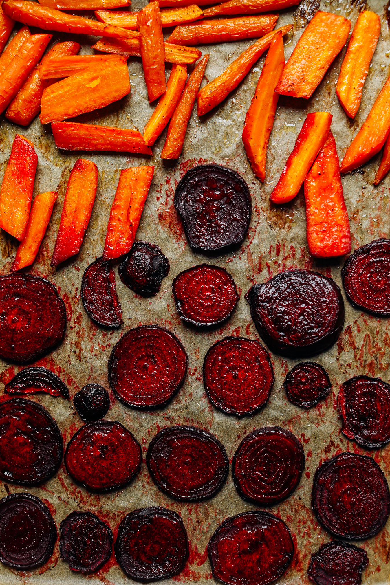 Baking sheet with freshly roasted carrots and beet slices for dipping in our Easy Vegan Crudite recipe