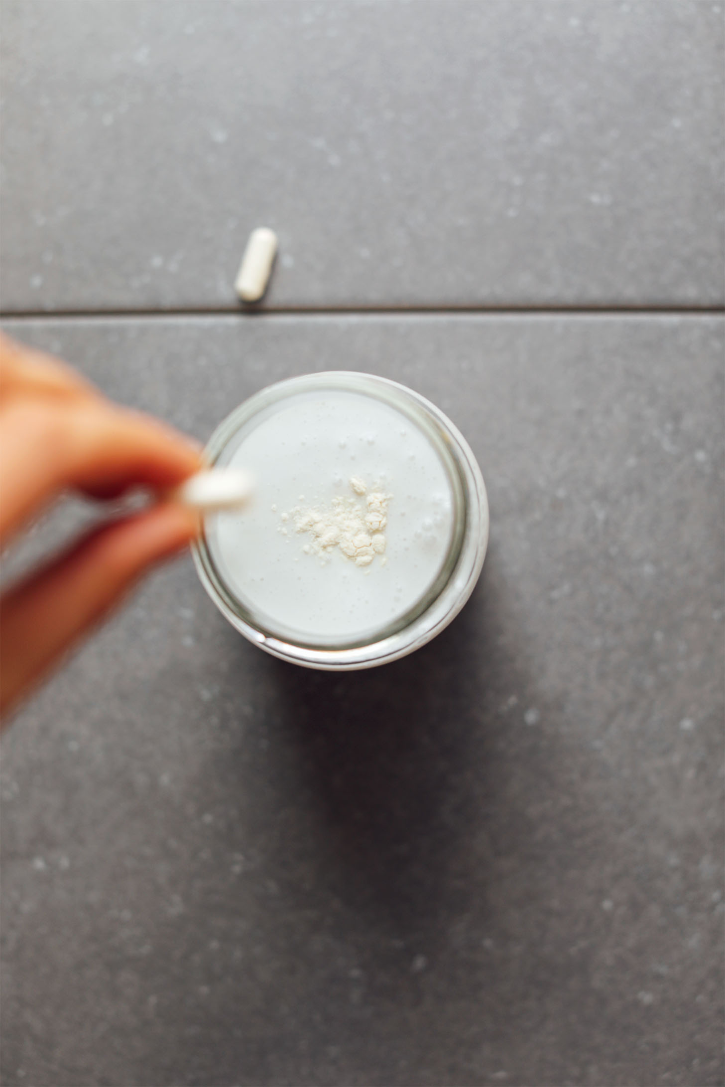Emptying probiotic capsule into the coconut yogurt
