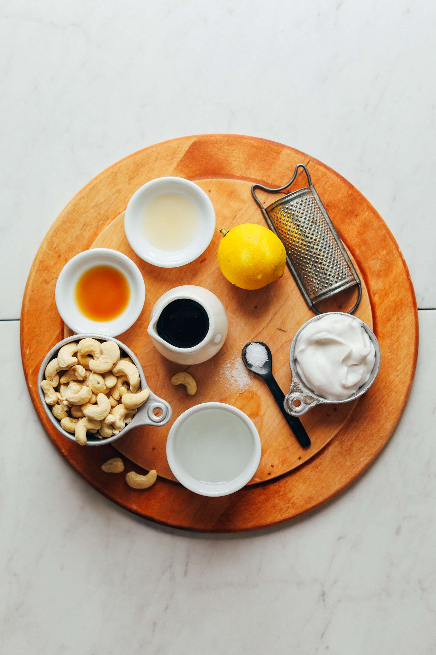 Cashews, lemon juice, and other plant-based ingredients for making Creamy Cashew Buttercream Frosting