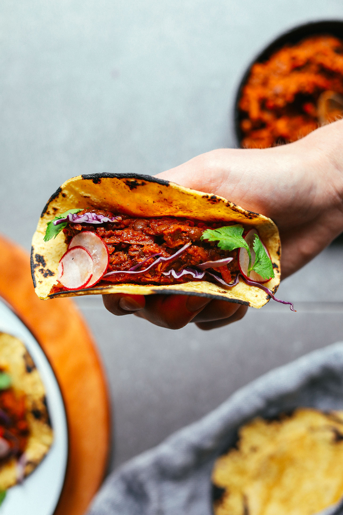Holding up a Vegan Barbacoa Taco for a healthy gluten-free meal