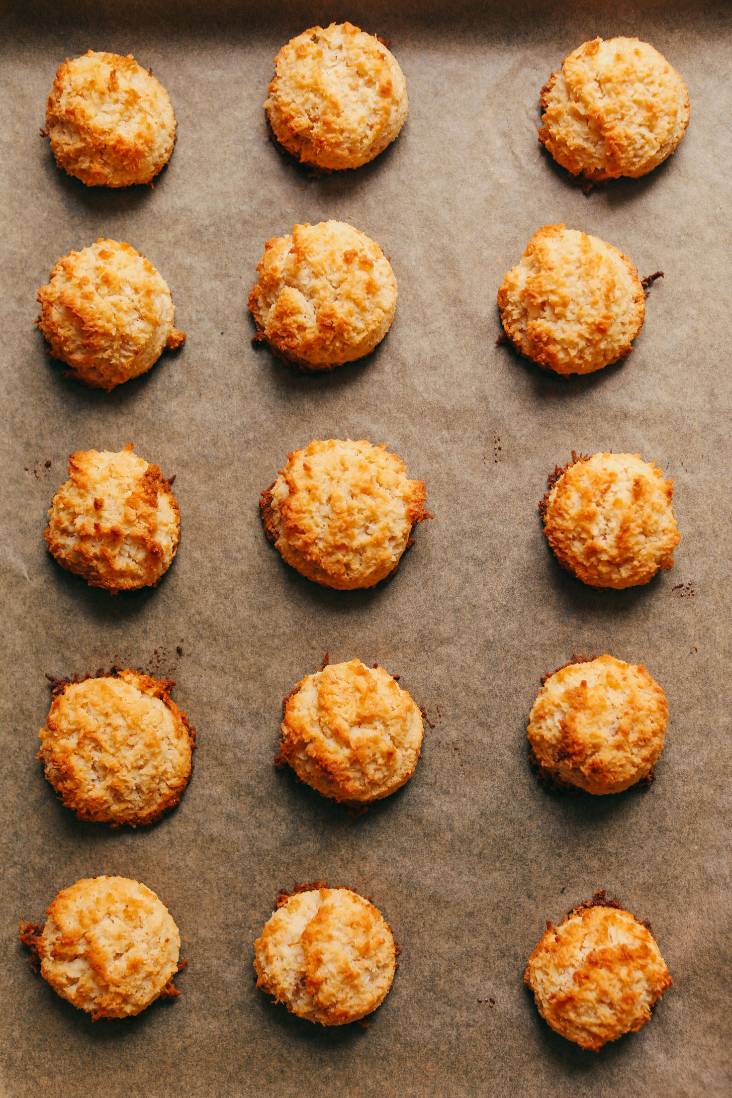 Freshly baked Crispy Vegan Macaroons on a parchment-lined baking sheet