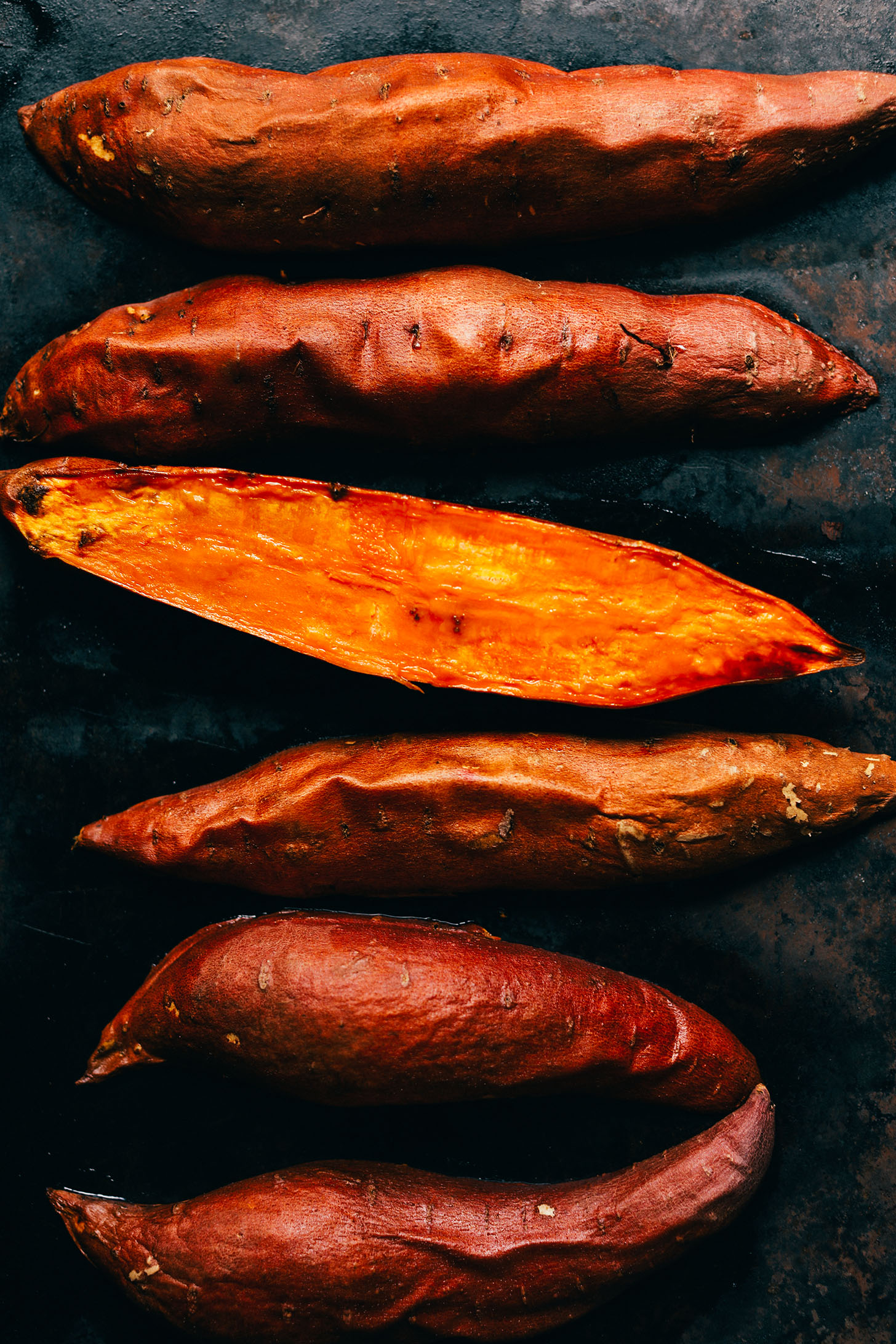 Perfectly baked sweet potatoes on a baking sheet