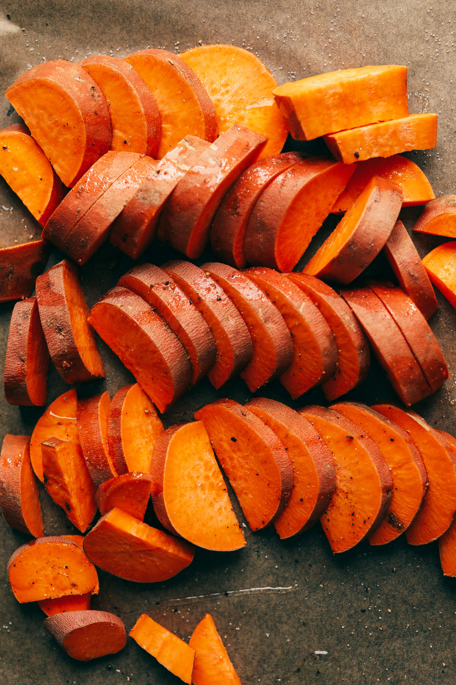 Sliced sweet potato ready for roasting and adding to this green salad