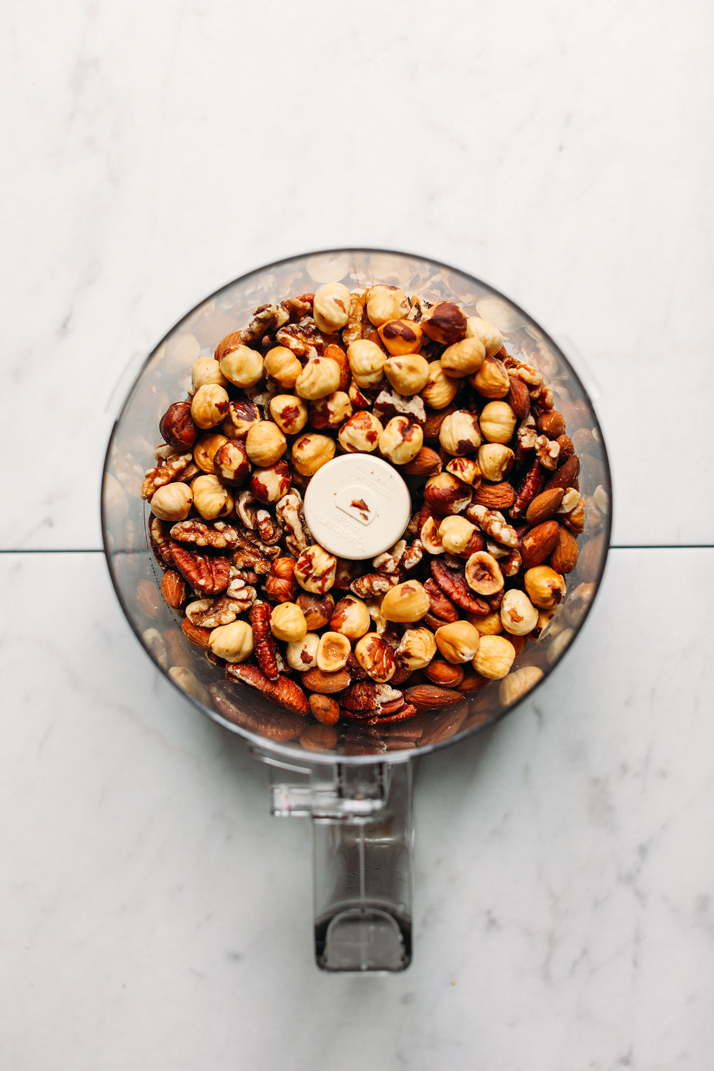 Roasted nuts in a food processor for making homemade nut butter