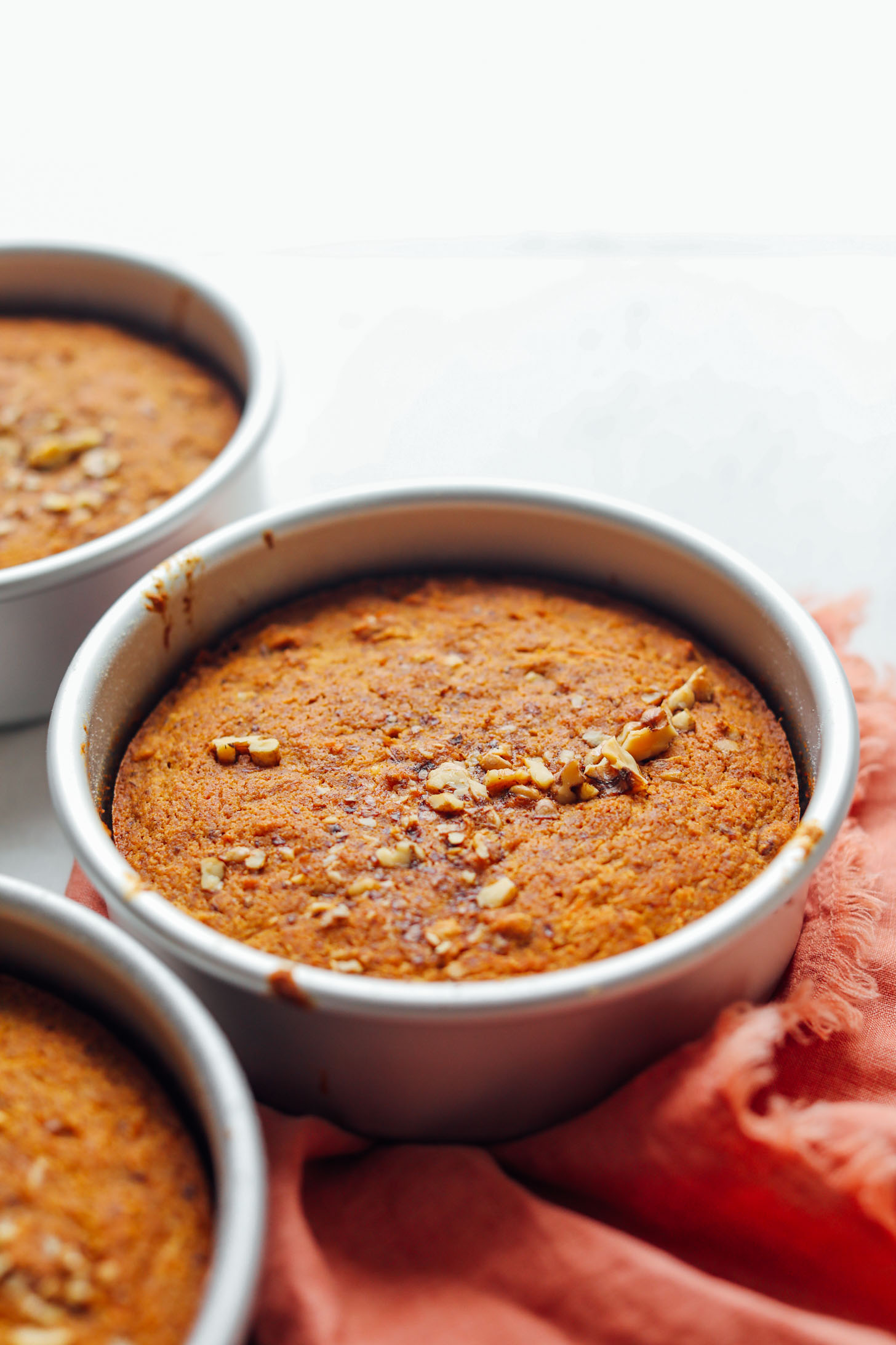 Round baking pans with freshly baked Vegan Gluten-Free Carrot Cake