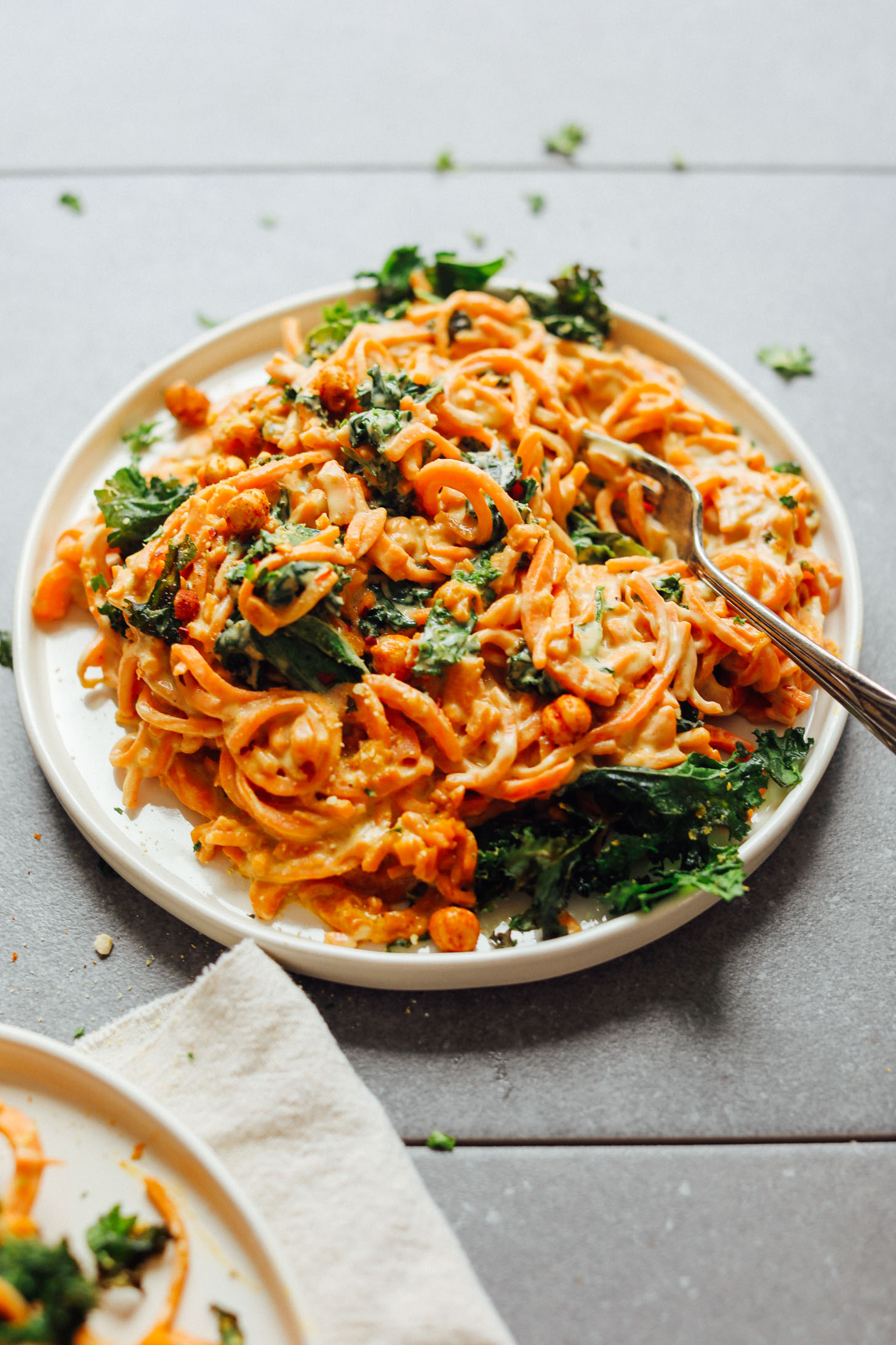 Close up shot of a plate of Garlicky Sweet Potato Pasta with Crispy Kale for a simple gluten-free vegan meal
