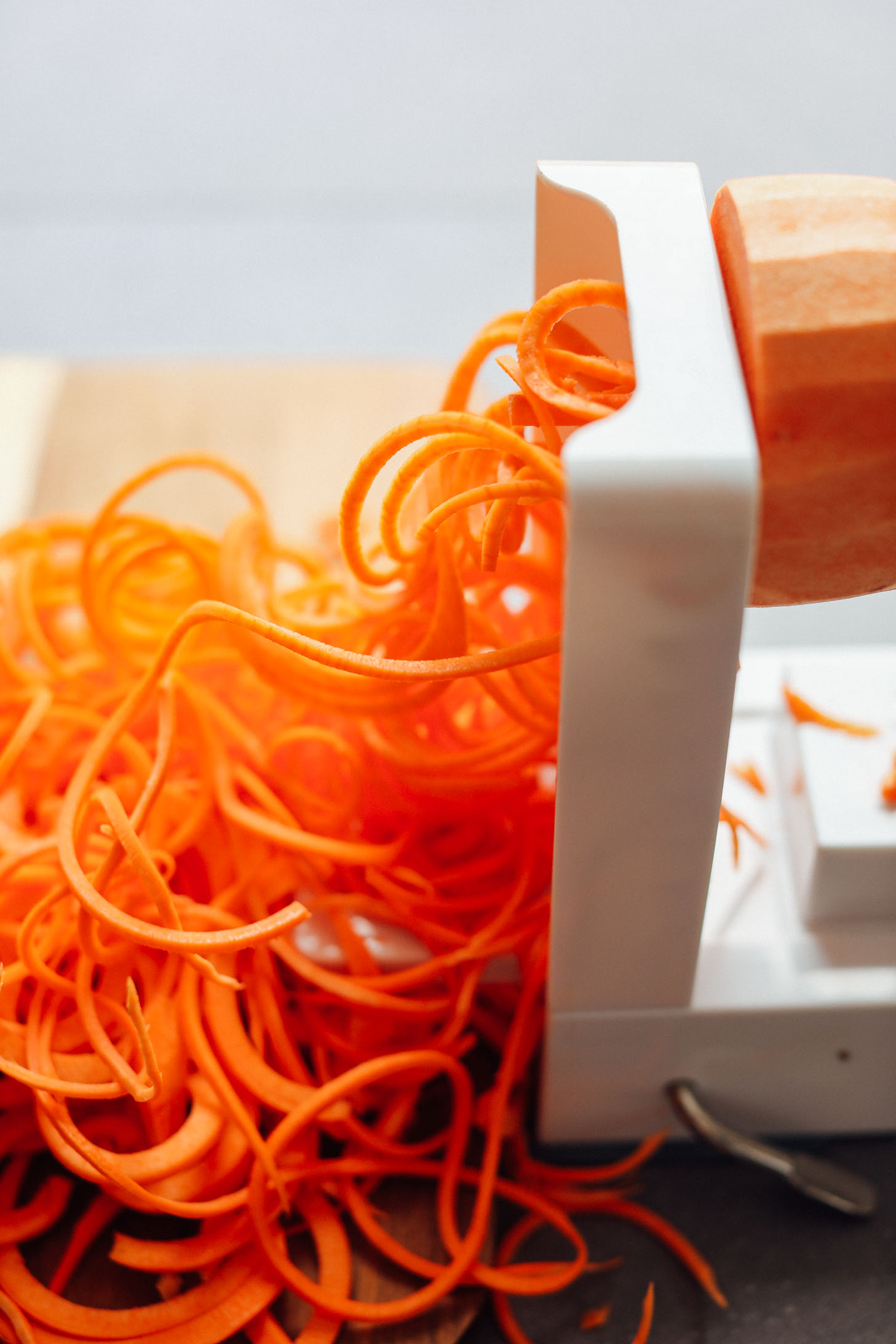 Using a spiralizer to make Garlicky Sweet Potato Pasta with Crispy Kale