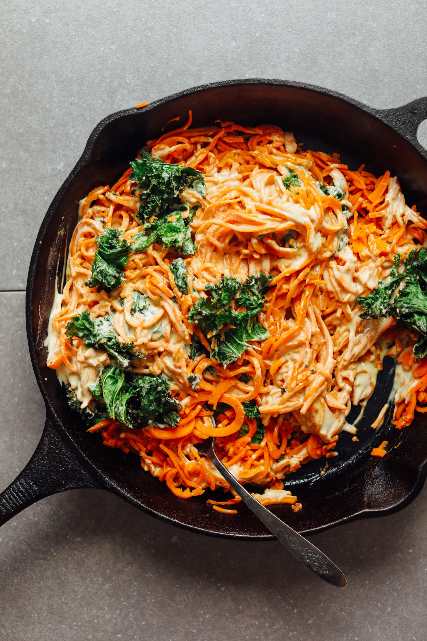 Cast iron skillet with gluten-free vegan Garlicky Sweet Potato Pasta with Crispy Kale