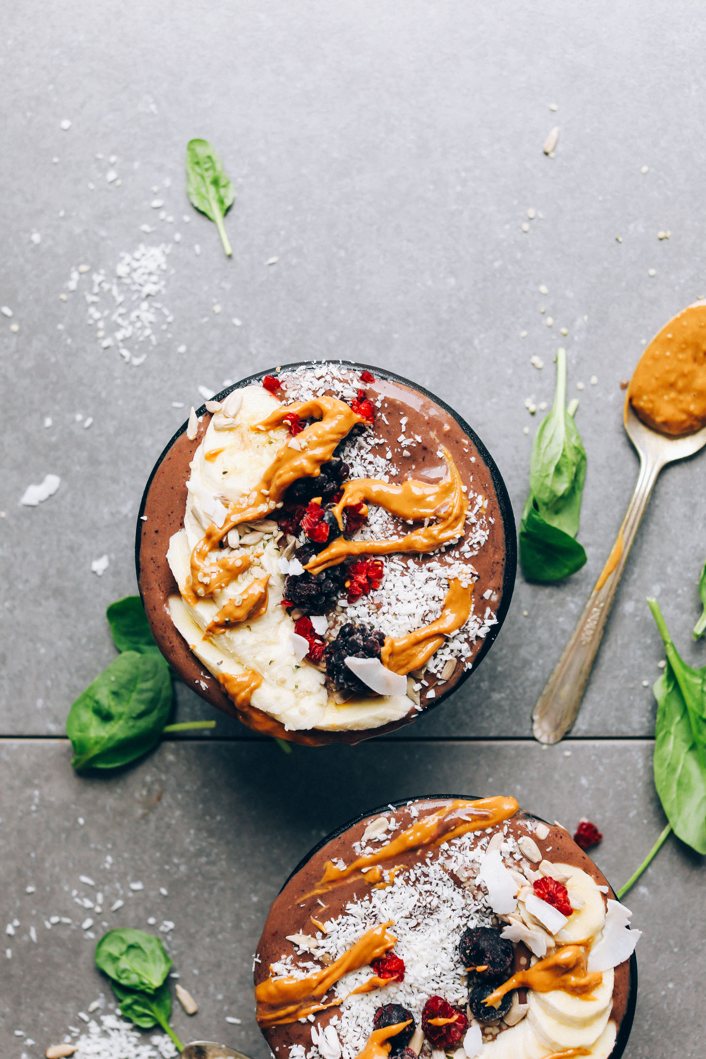 Peanut Butter and Jelly Acai Bowls topped with fresh fruits, peanut butter, and coconut