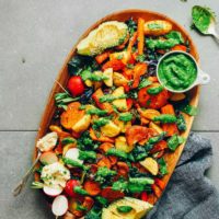 Serving platter filled with Amazing Roasted Vegetable Salad & Chimichurri