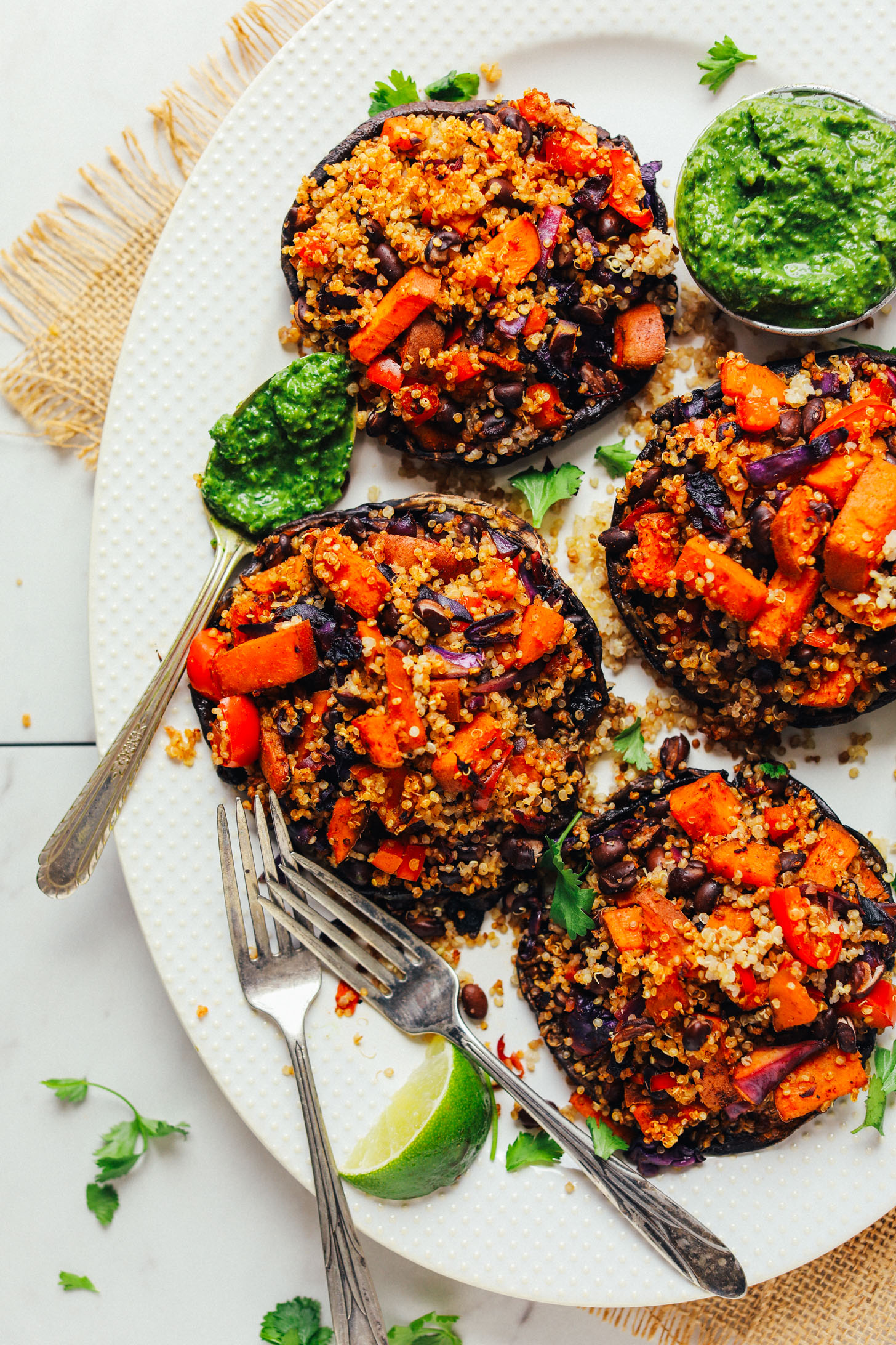 Large serving platter with four Vegetable Quinoa Stuffed Portobello Mushrooms for a healthy plant-based meal