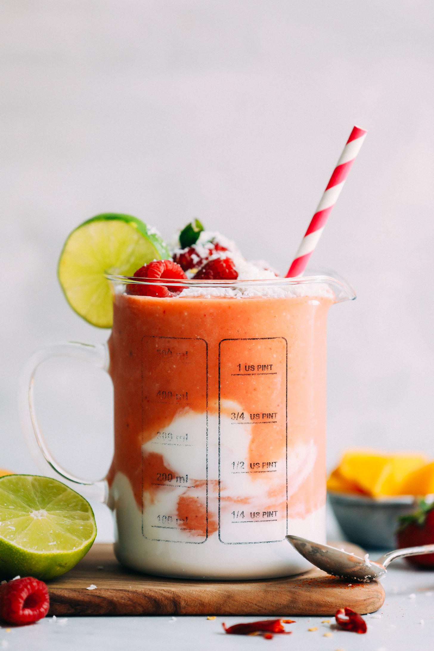 Close up shot of our banana-free delicious vegan smoothie made from mango, berries, lime, ginger, and coconut