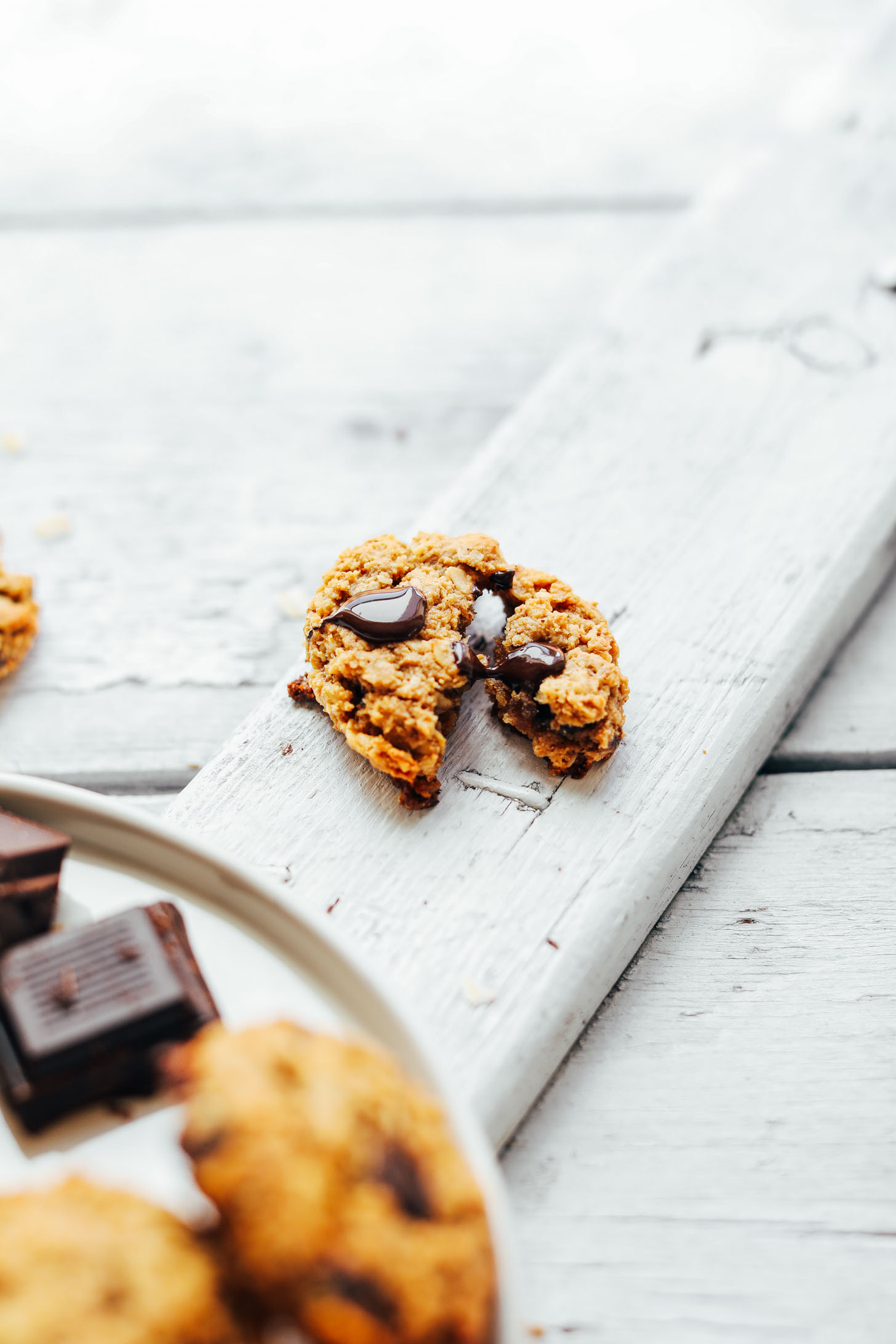 Breaking apart a warm Gluten-Free Oatmeal Chocolate Chip Cookie