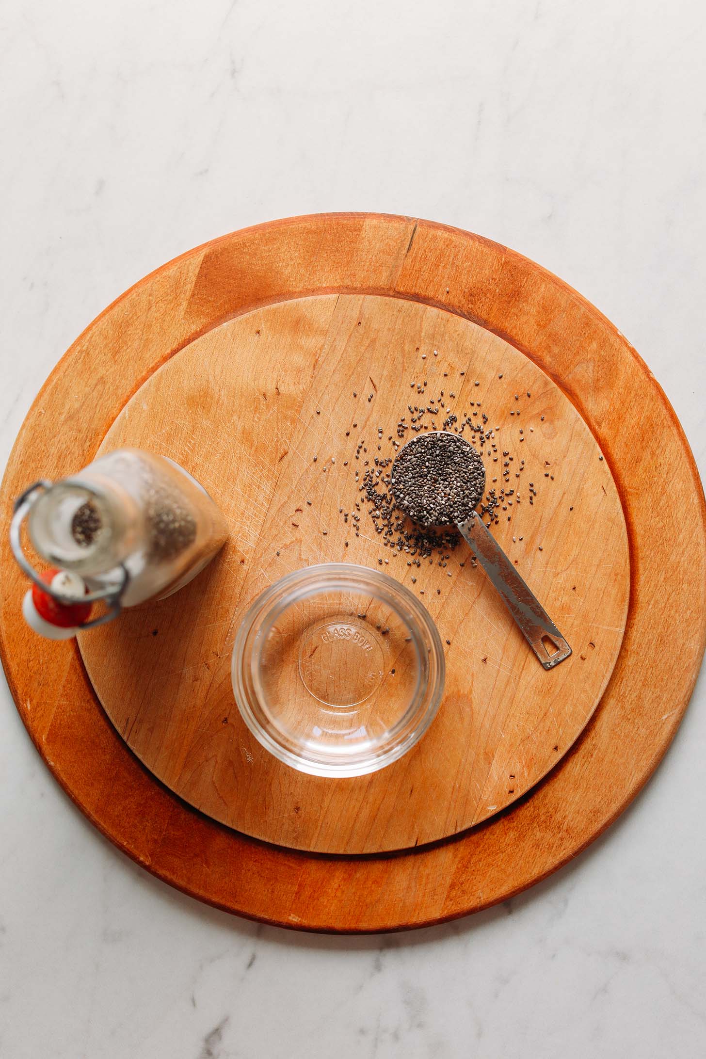 Chia seeds and water on a cutting board for making our chia egg recipe