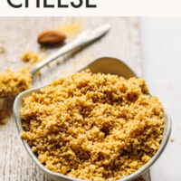 Bowl of cashew-free vegan parmesan cheese next to a small dish of olive oil