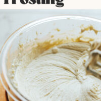Electric mixer resting over a bowl of vegan naturally sweetened buttercream frosting