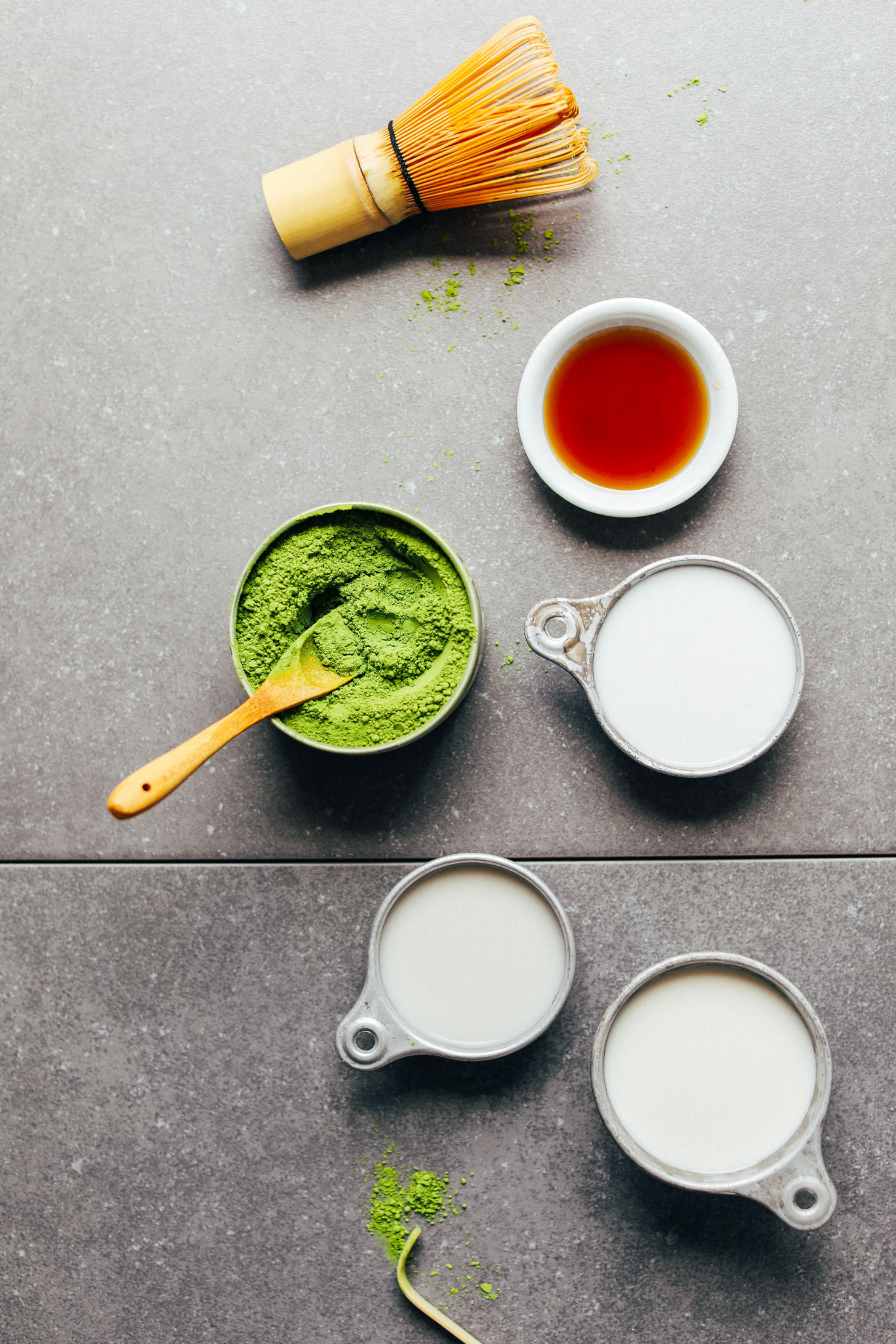 Bamboo whisk, matcha, maple syrup, and nut milks for making the best Matcha Latte