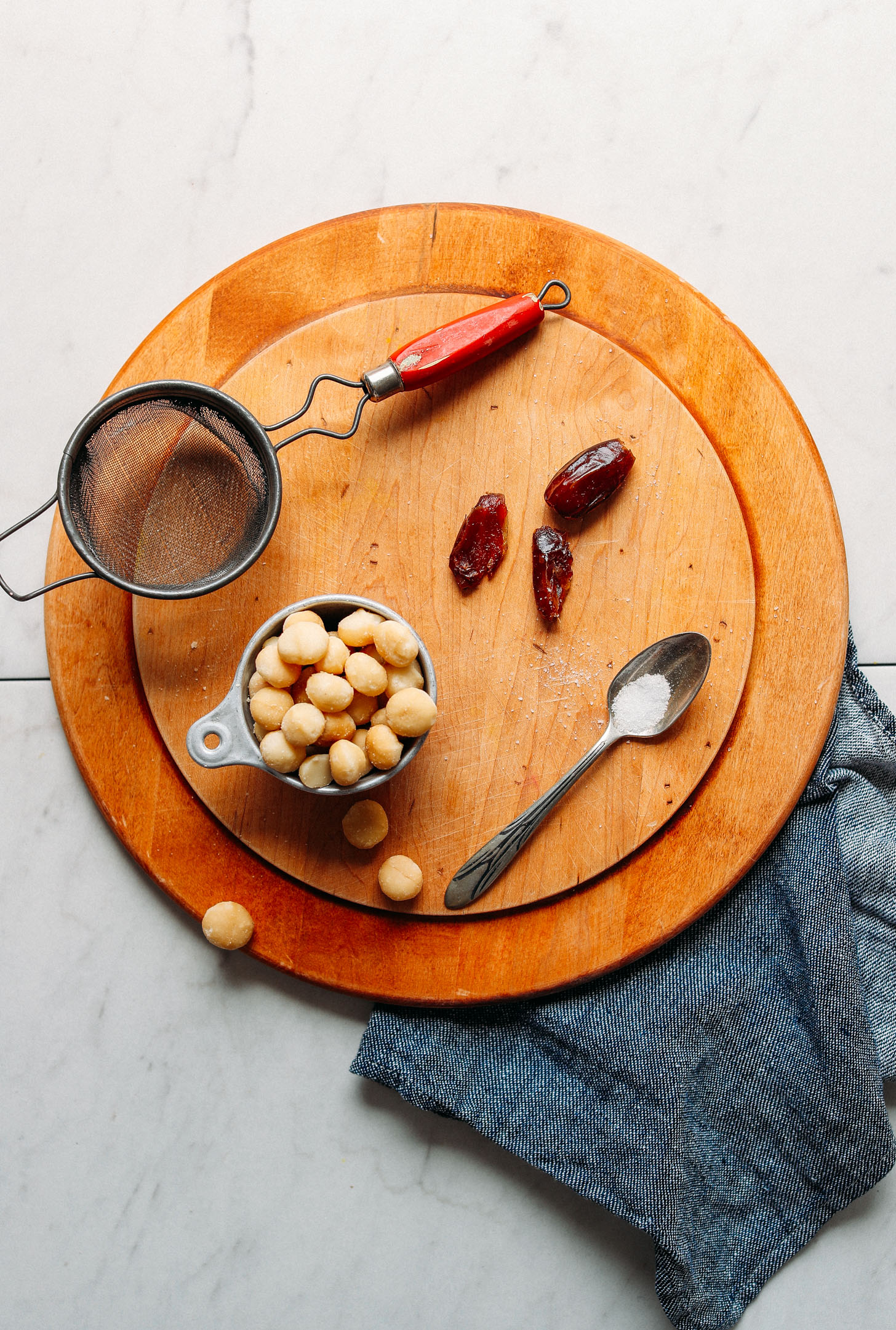 Wood cutting board with ingredients for making our homemade Macadamia Milk recipe