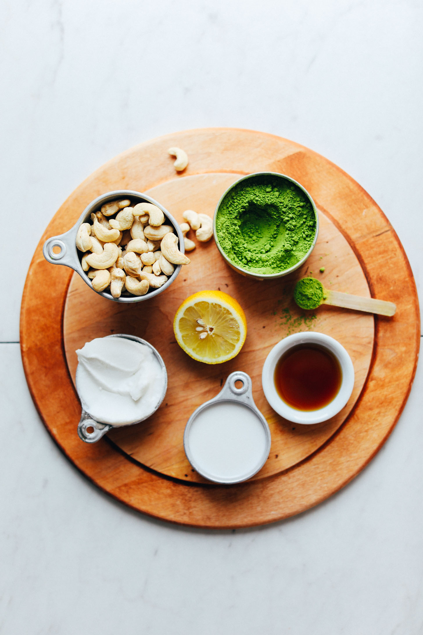 Cashews, coconut yogurt, lemon, coconut milk, maple syrup, and matcha for making Matcha Swirl Cheesecake