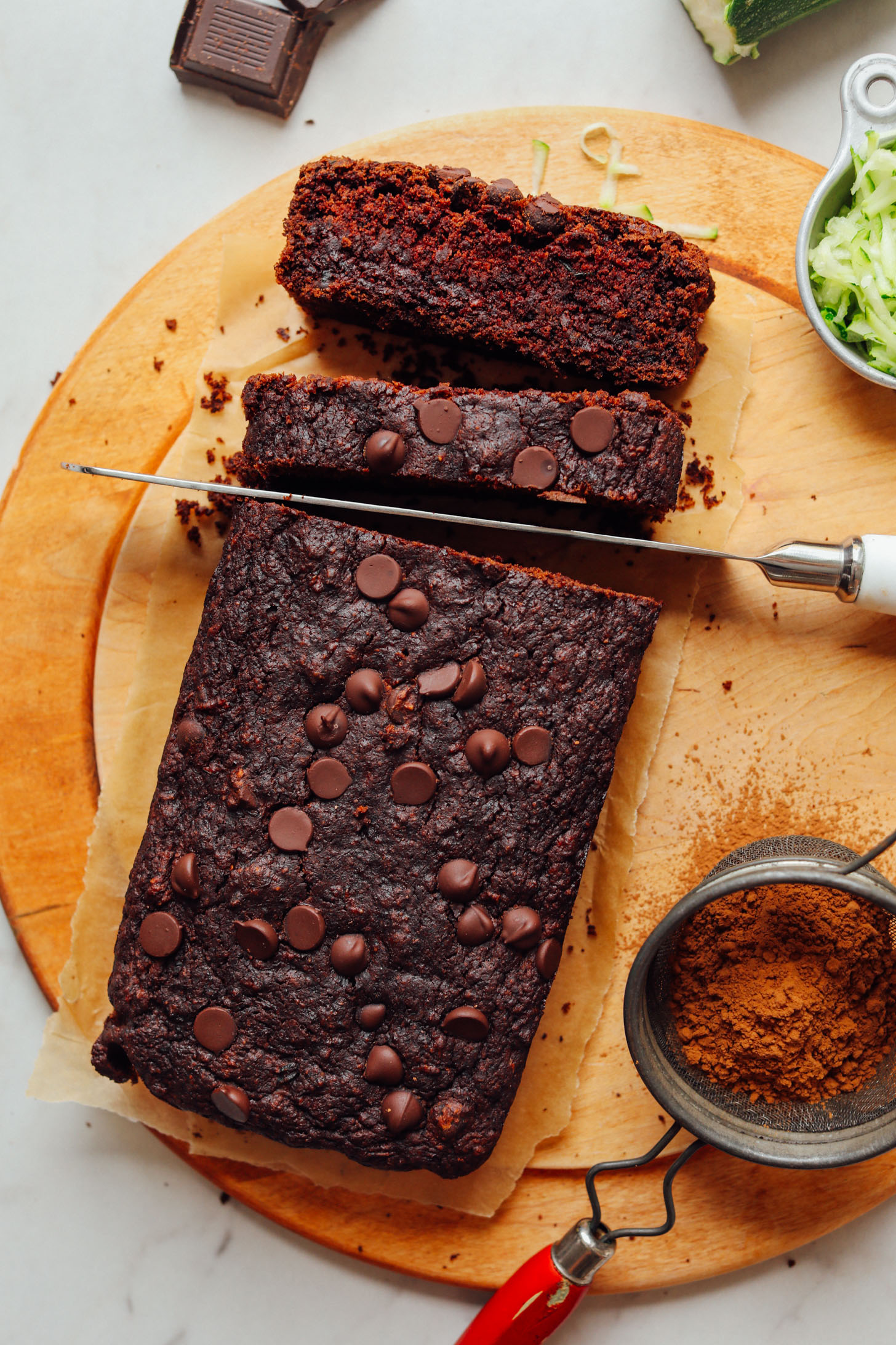 Slicing into a loaf of Vegan Chocolate Chip Zucchini Bread