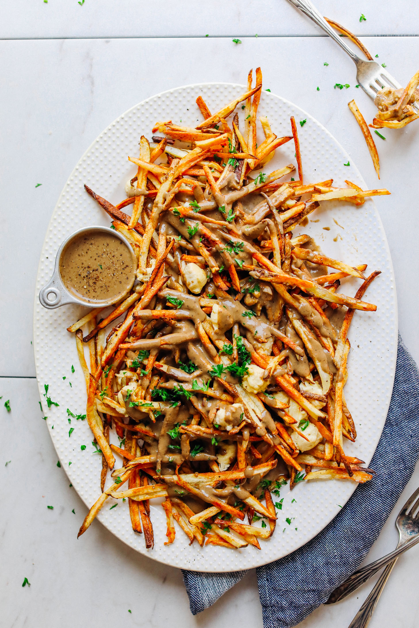 Large ceramic platter filled with amazing Vegan Poutine