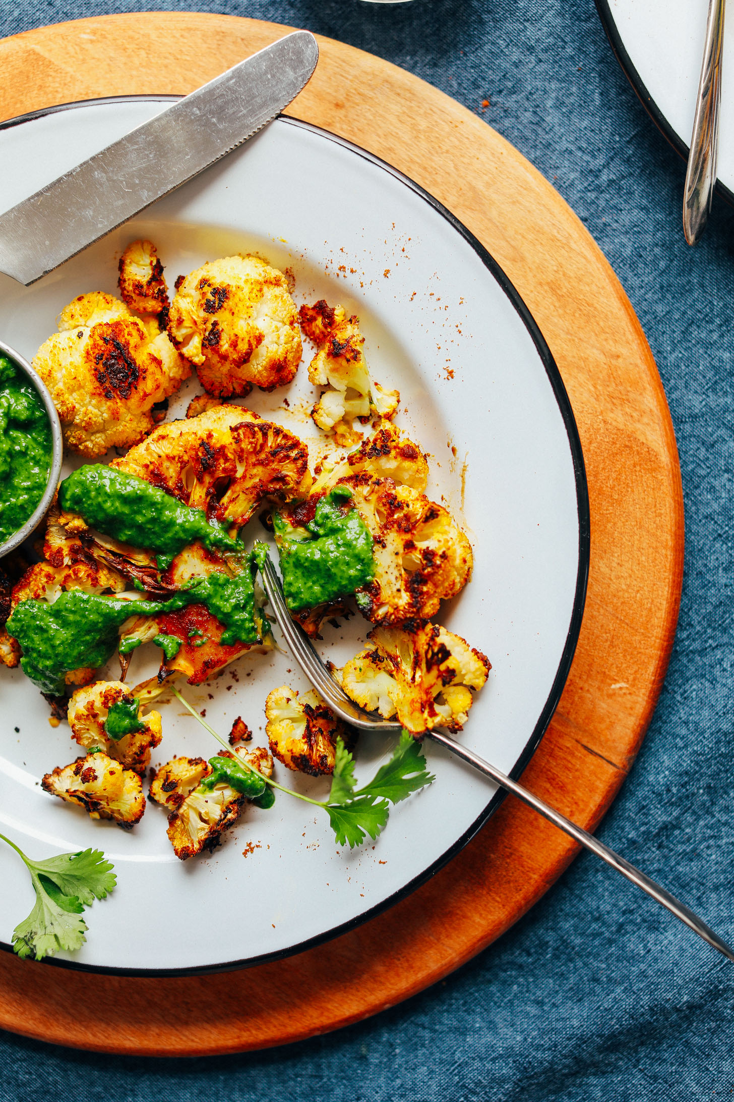 A dinner plate with vegan gluten-free Shawarma Roasted Cauliflower Steak and Green Chutney